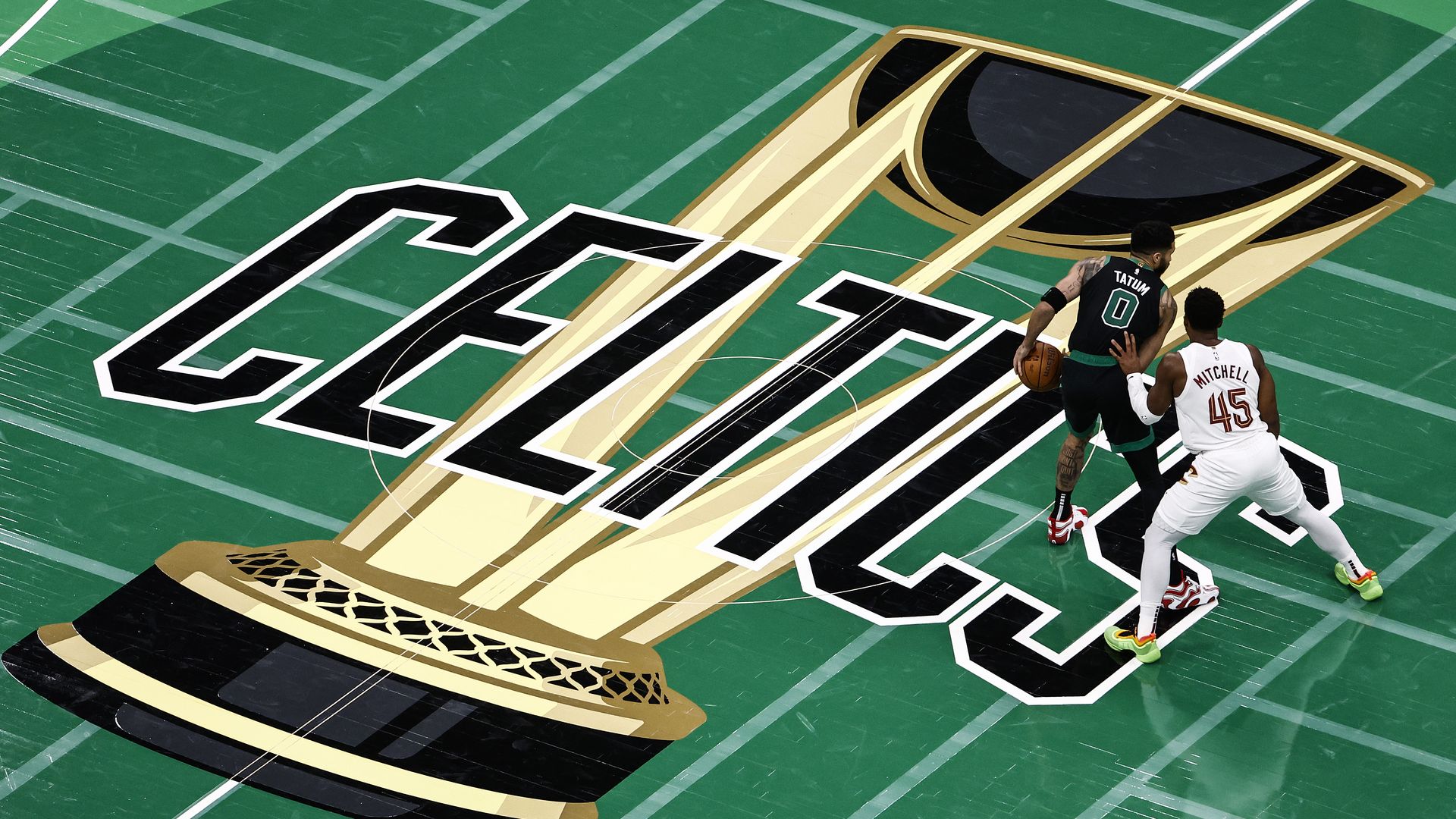 Image of Celtics center court with Jason Tatum and Donovan Mitchell playing basketball