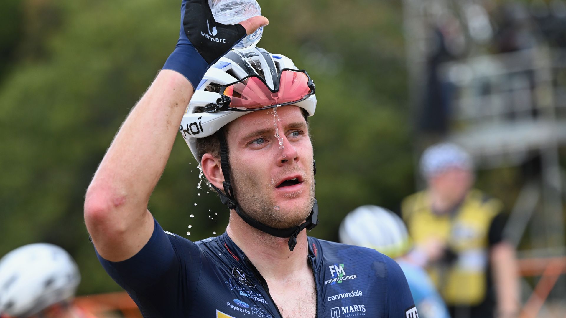Photo of a cyclist pouring water on his head