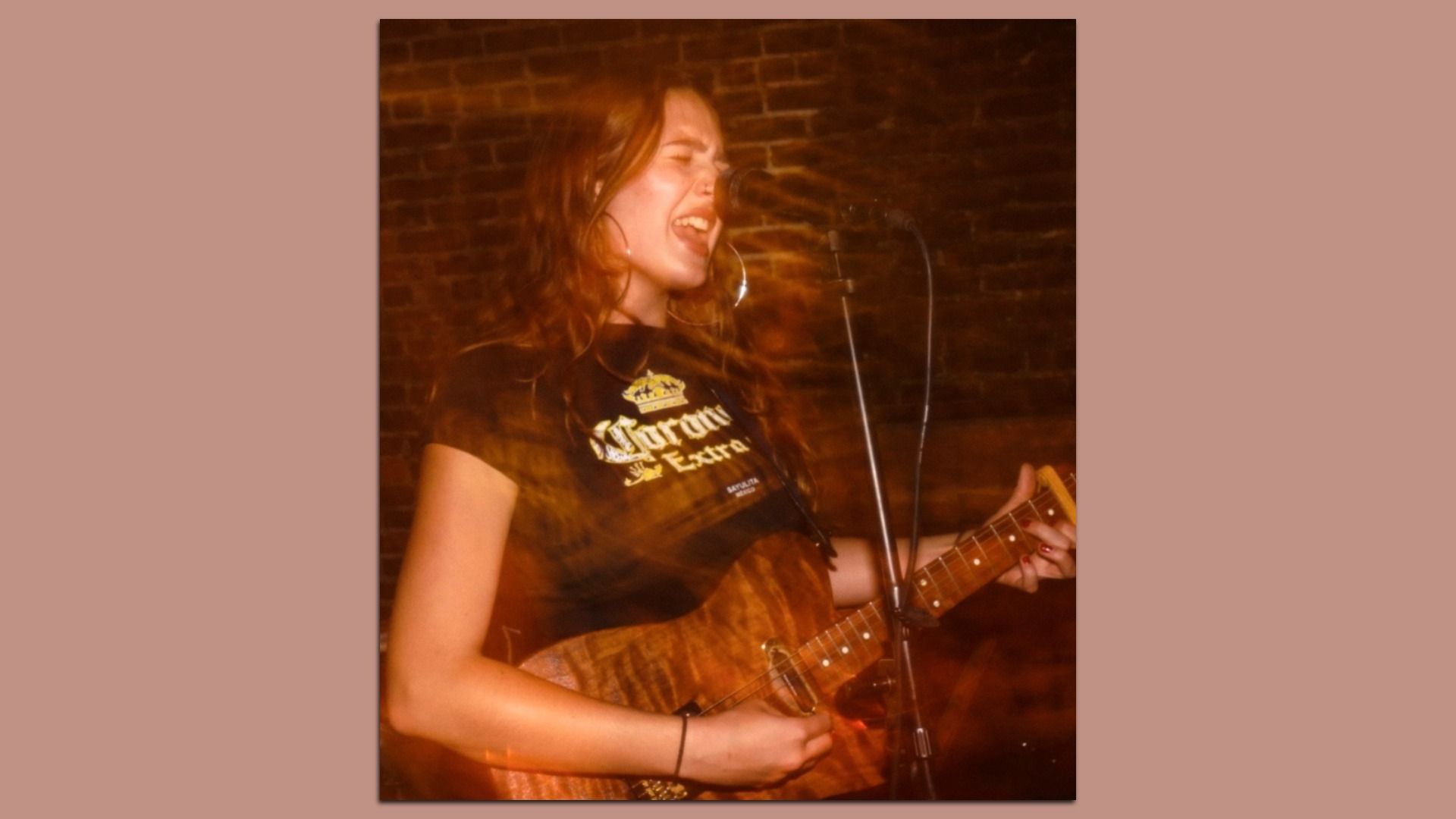 Lena Joy singing while playing guitar