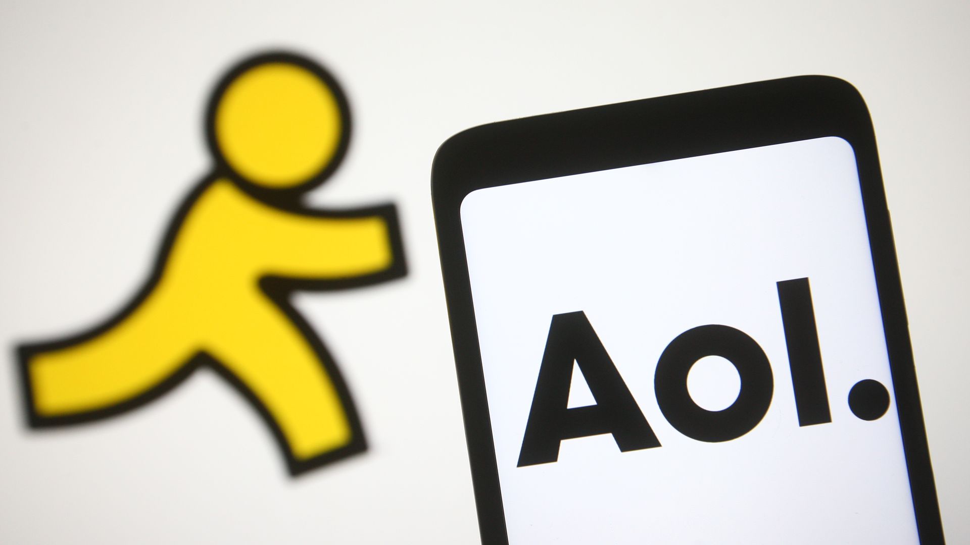 The AOL logo is displayed on a smartphone screen, with the previous yellow running man icon in the background.