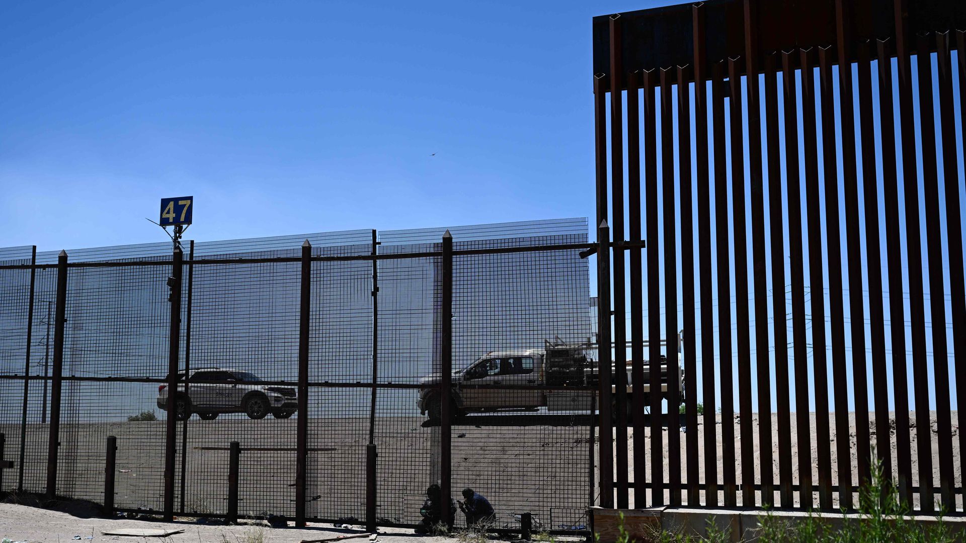 Contractors weld closed a hole in a fence used by migrants to climb though the border wall along the US-Mexico border in El Paso, Texas on May 1
