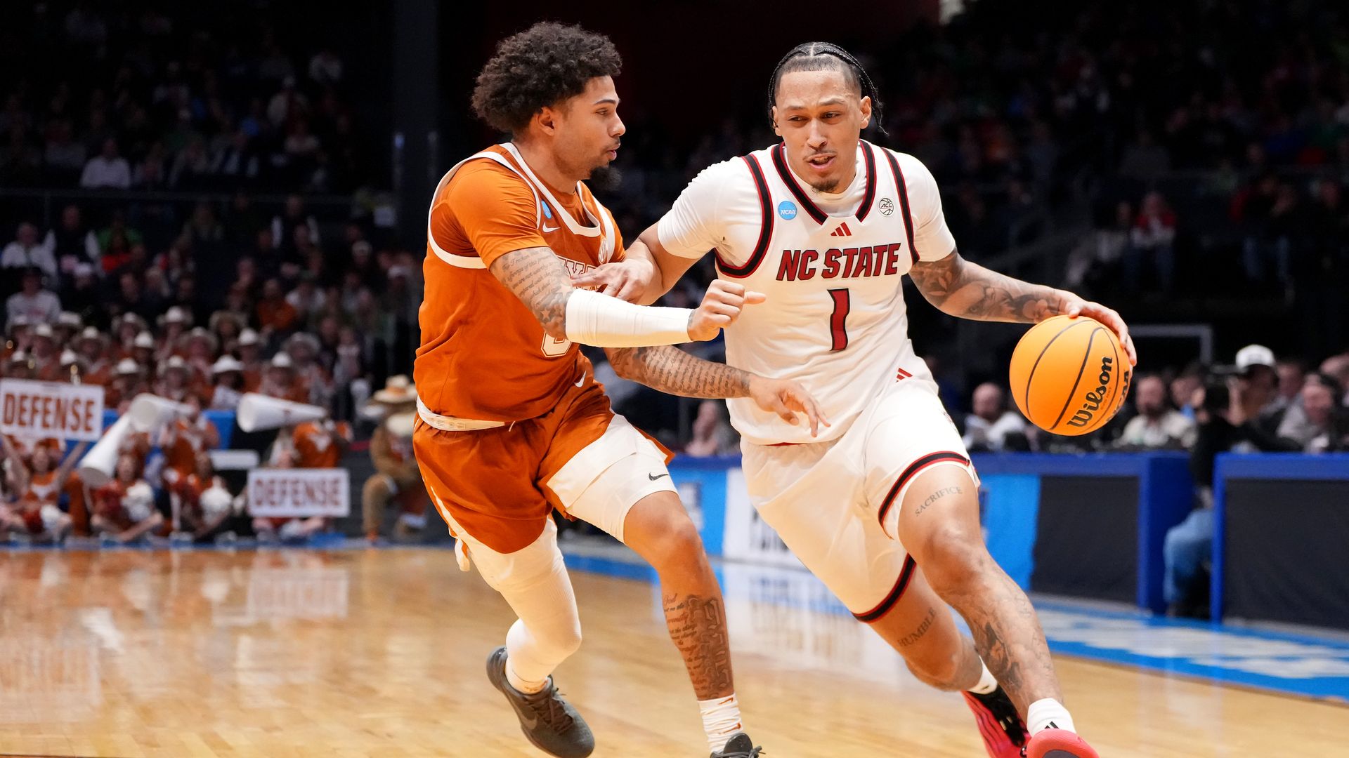 DAYTON, OHIO - MARCH 17: Darrion Williams #1 of the NC State Wolfpack drives to the basket against Jordan Pope #0 of the Texas Longhorns during the second half in the First Four game of the 2026 NCAA Men's Basketball Tournament at UD Arena on March 17, 2026 in Dayton, Ohio. (Photo by Dylan Buell/Get