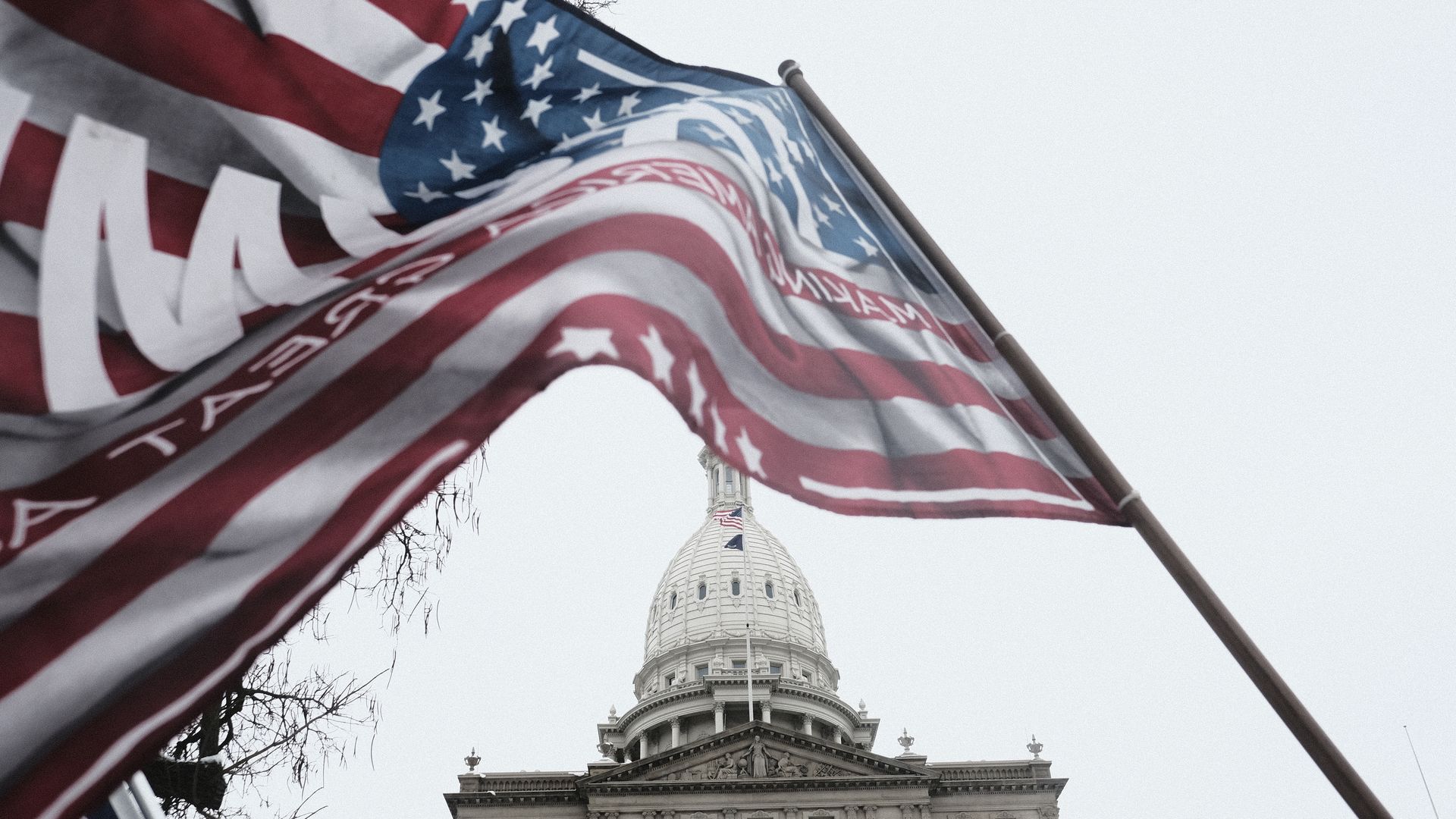 Donald Trump supporters march around the Michigan State Capitol Building to protest the certification of Joe Biden as the next president.