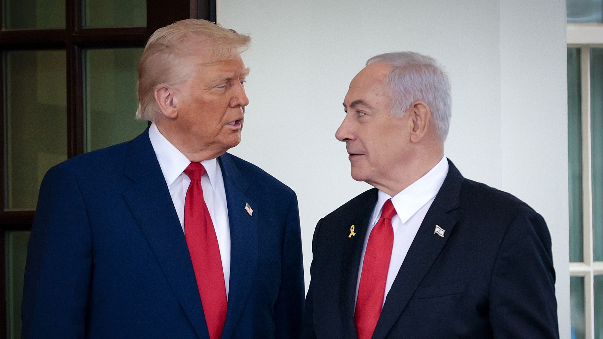 President Trump and Prime Minister Netanyahu at the White House in April 2025, facing each other with white shirts and red ties.
