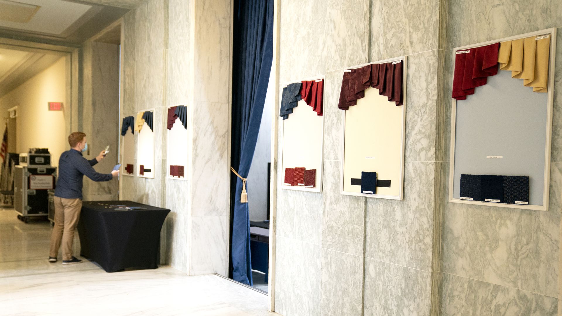 A House staffer shows off office drape choices before new members pick their congressional offices.