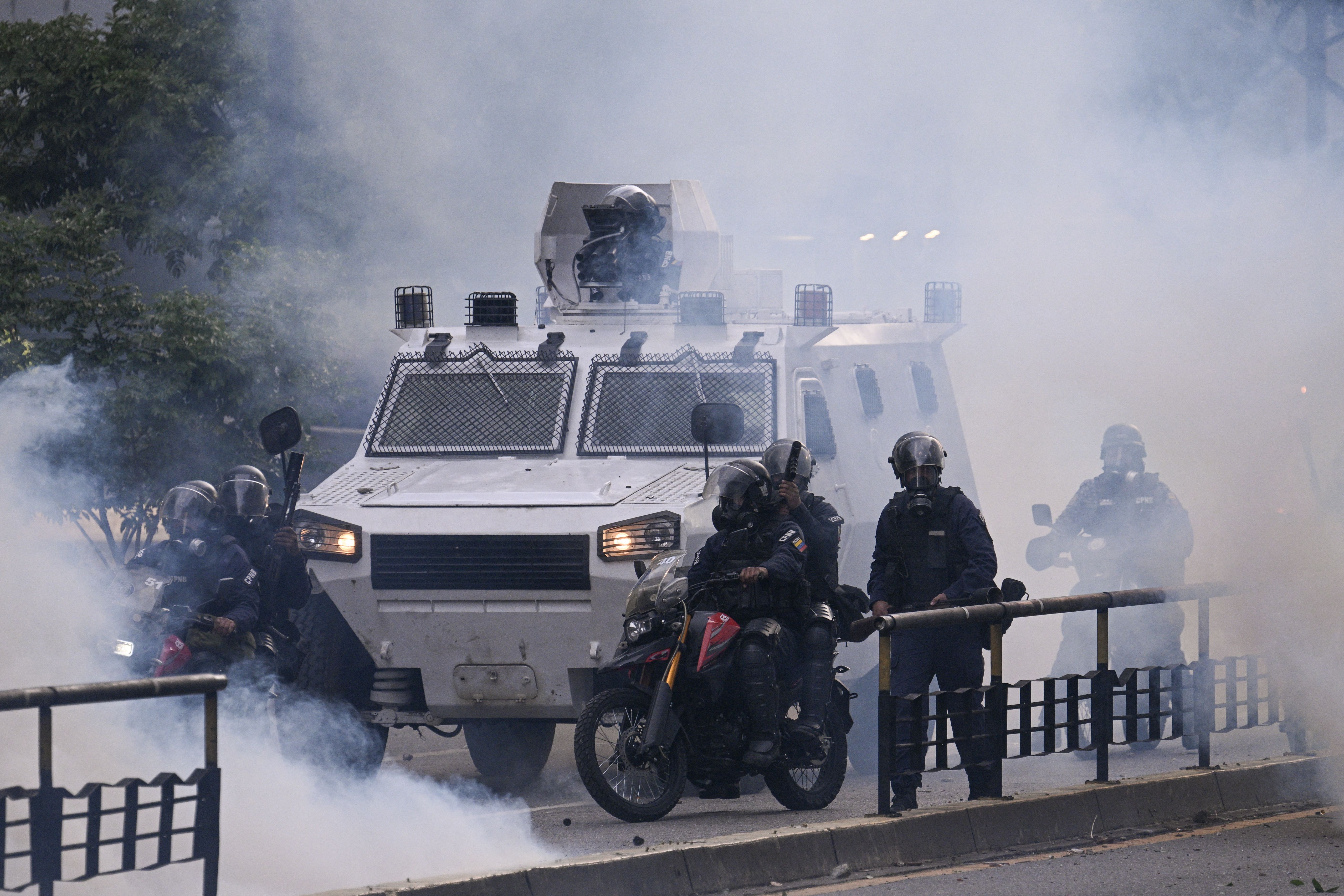 An armoured police car drives through tear gas during a protest against Venezuelan President Nicolas Maduro in Caracas on July 29.