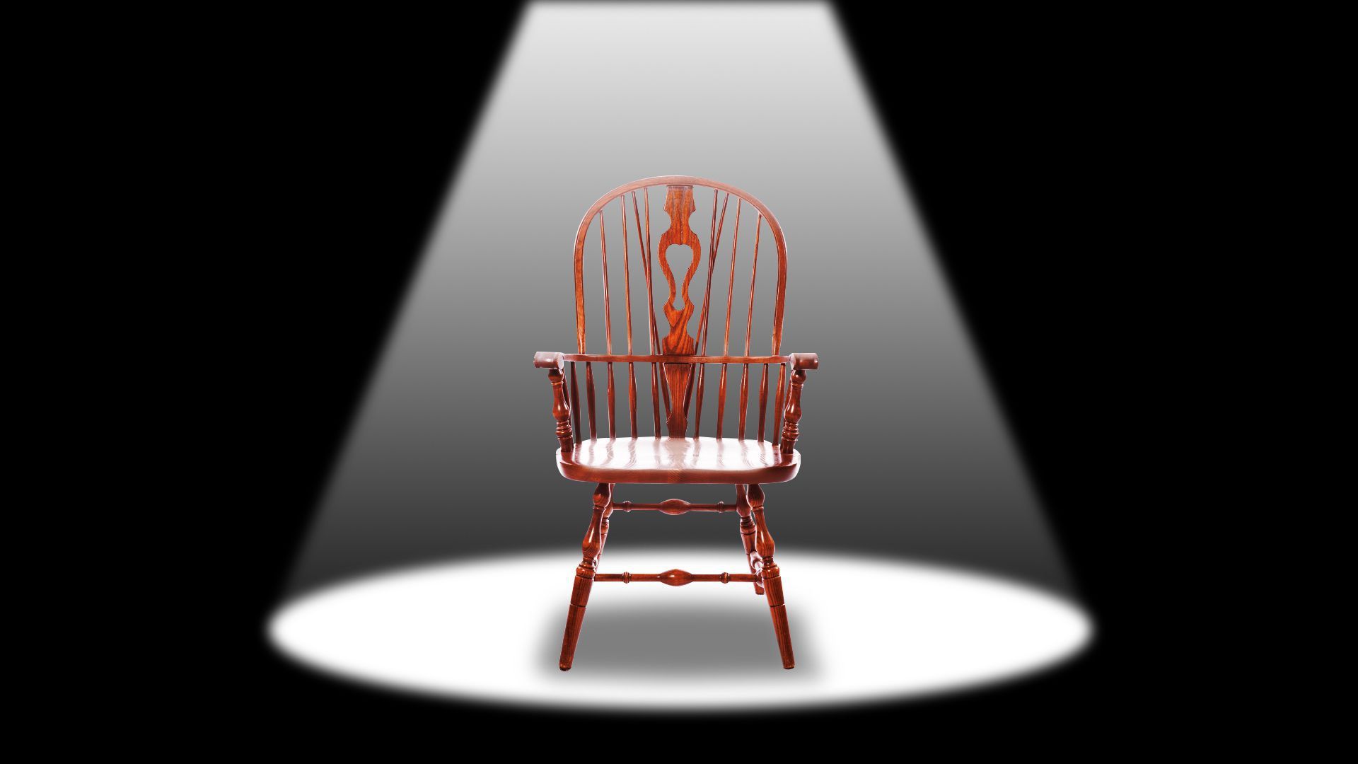 An illustration shows a red chair under a spotlight.