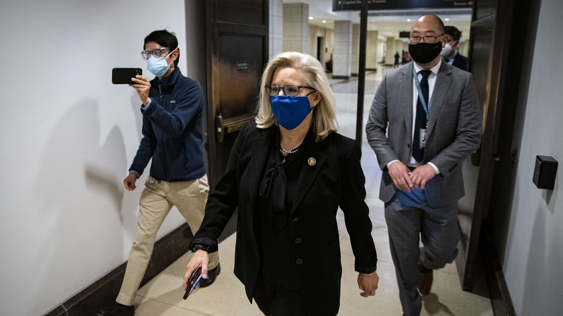 Representative Liz Cheney, a Republican from Wyoming, center, wears a protective mask as she walks to a vote on Capitol Hill in Washington, D.C., U.S., on Wednesday, Feb. 3
