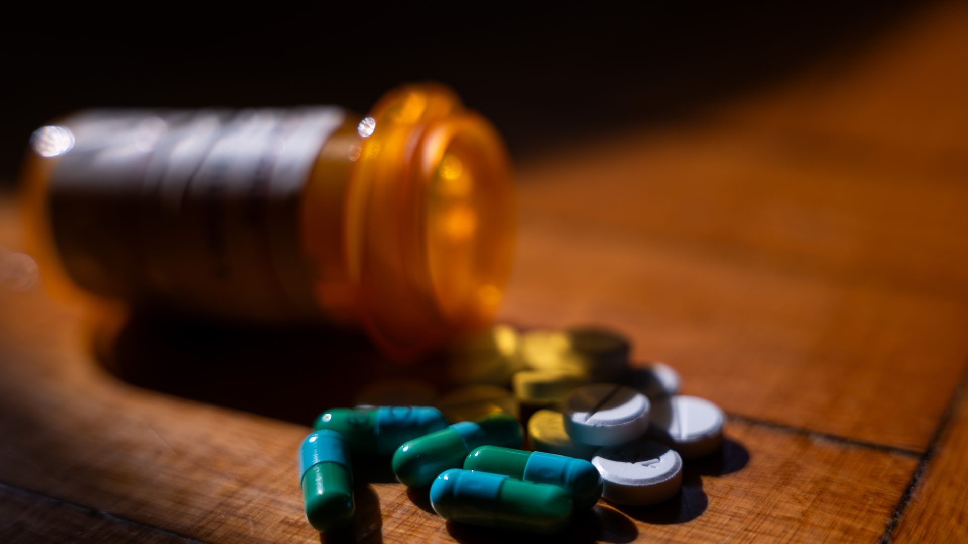 Pills spilled out of an empty bottle. 