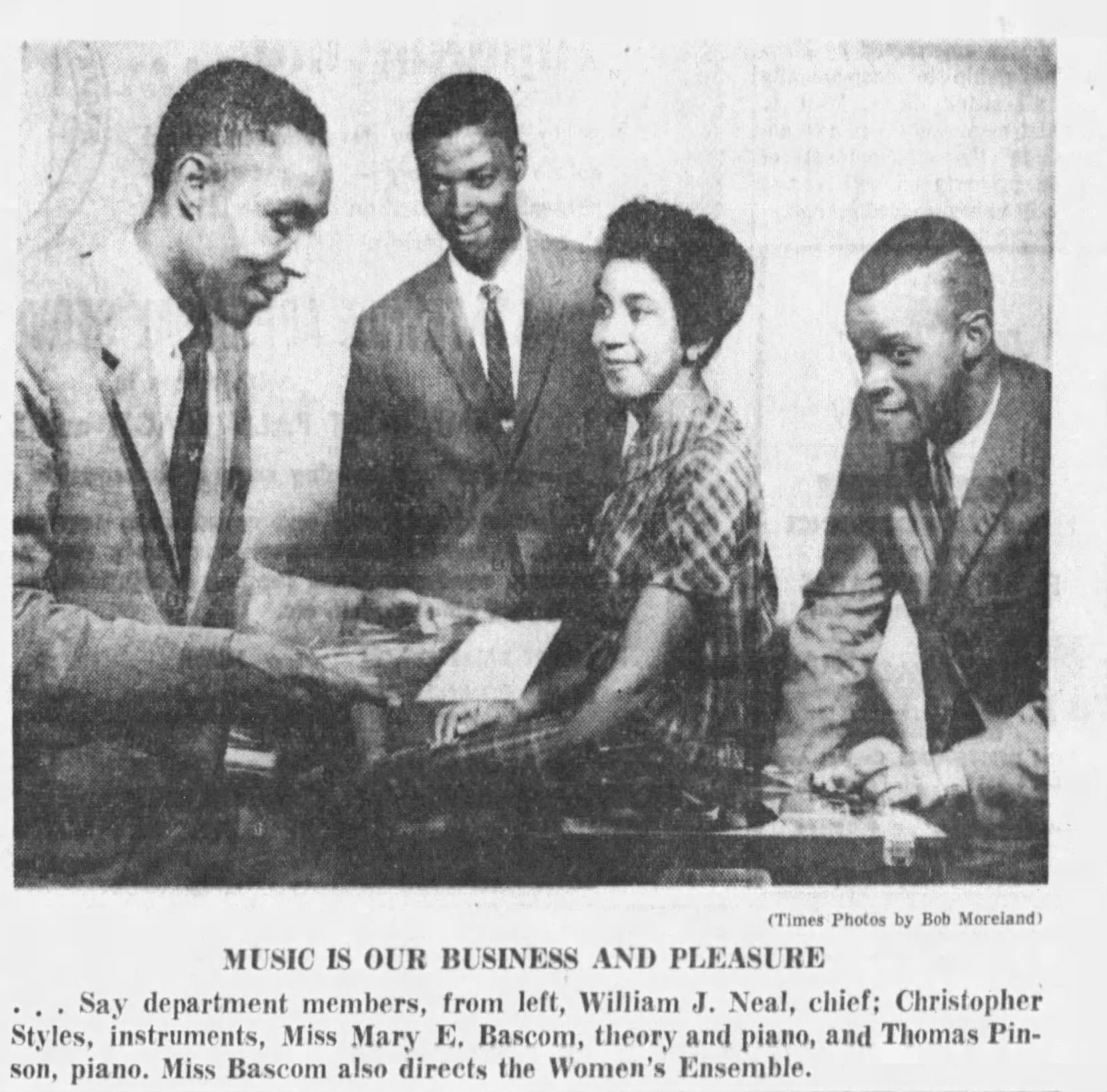 A photo of three men in suits and one woman in a plaid dress. The caption below reads, "Music is our business and pleasure ... say department members, from left, William J. Neal, chief; Christopher Styles, instruments; Miss Mary E. Bascom, theory and piano; and Thomas Pinson, piano."