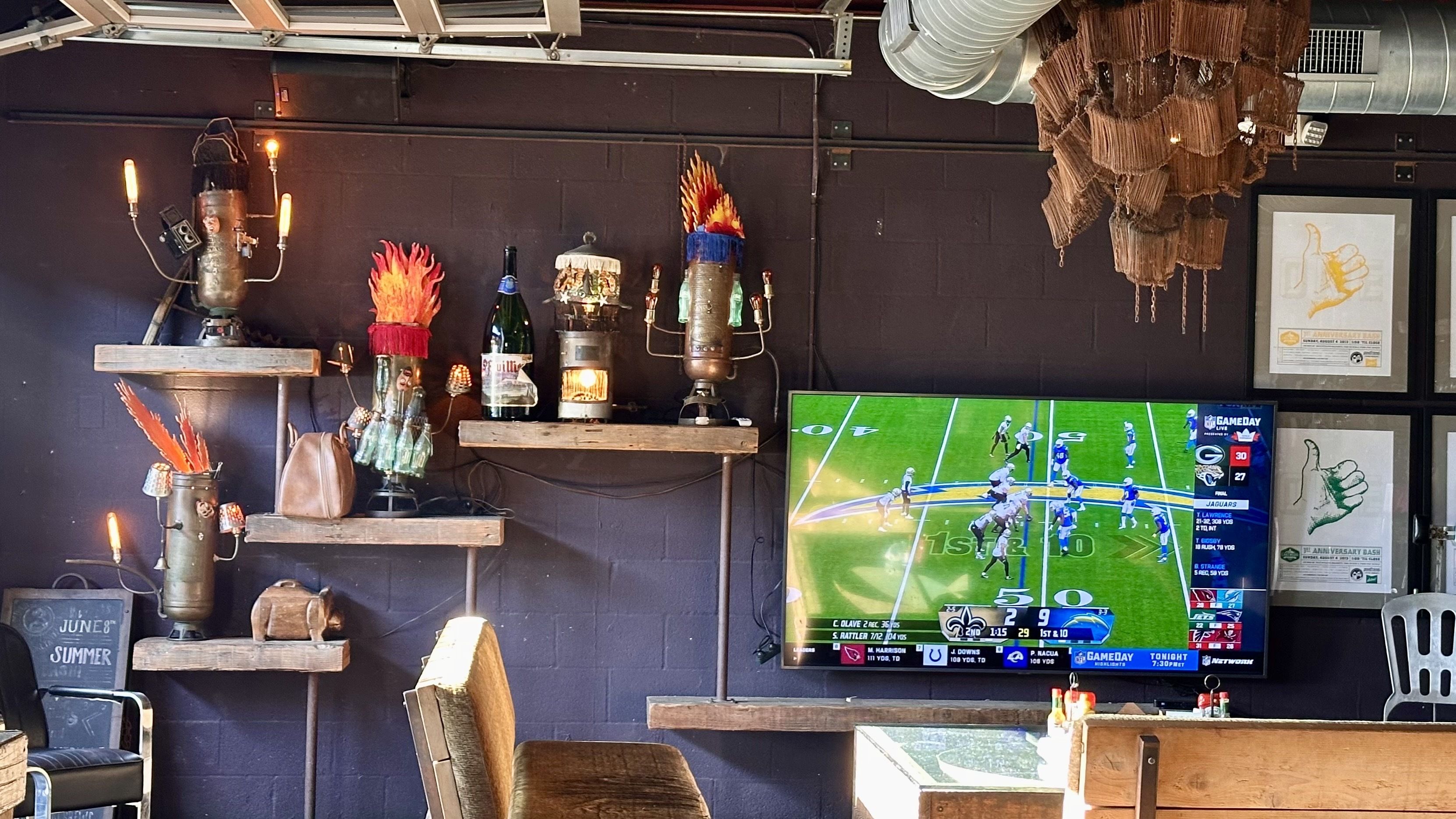 A photo of art on walls and a TV screen with football
