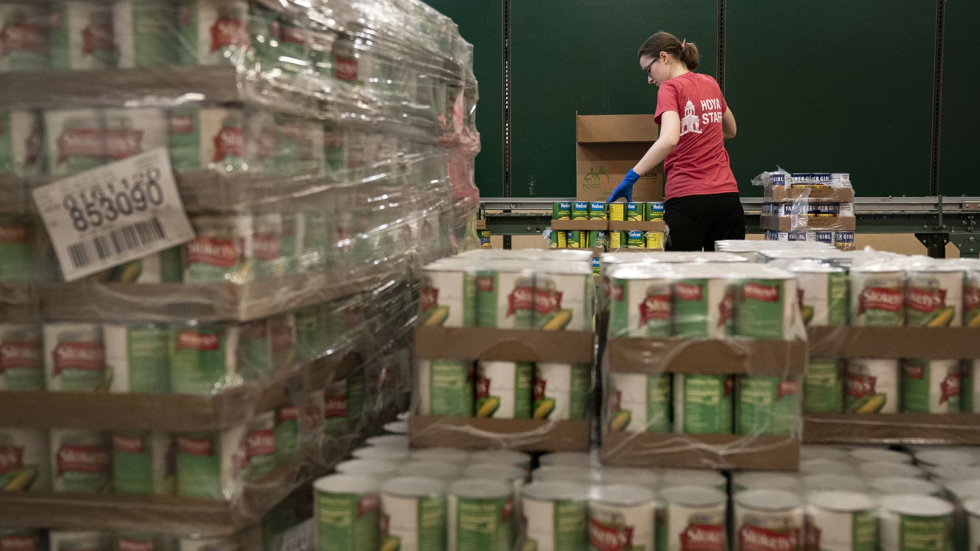 A woman stands in the Capital Area Food Bank