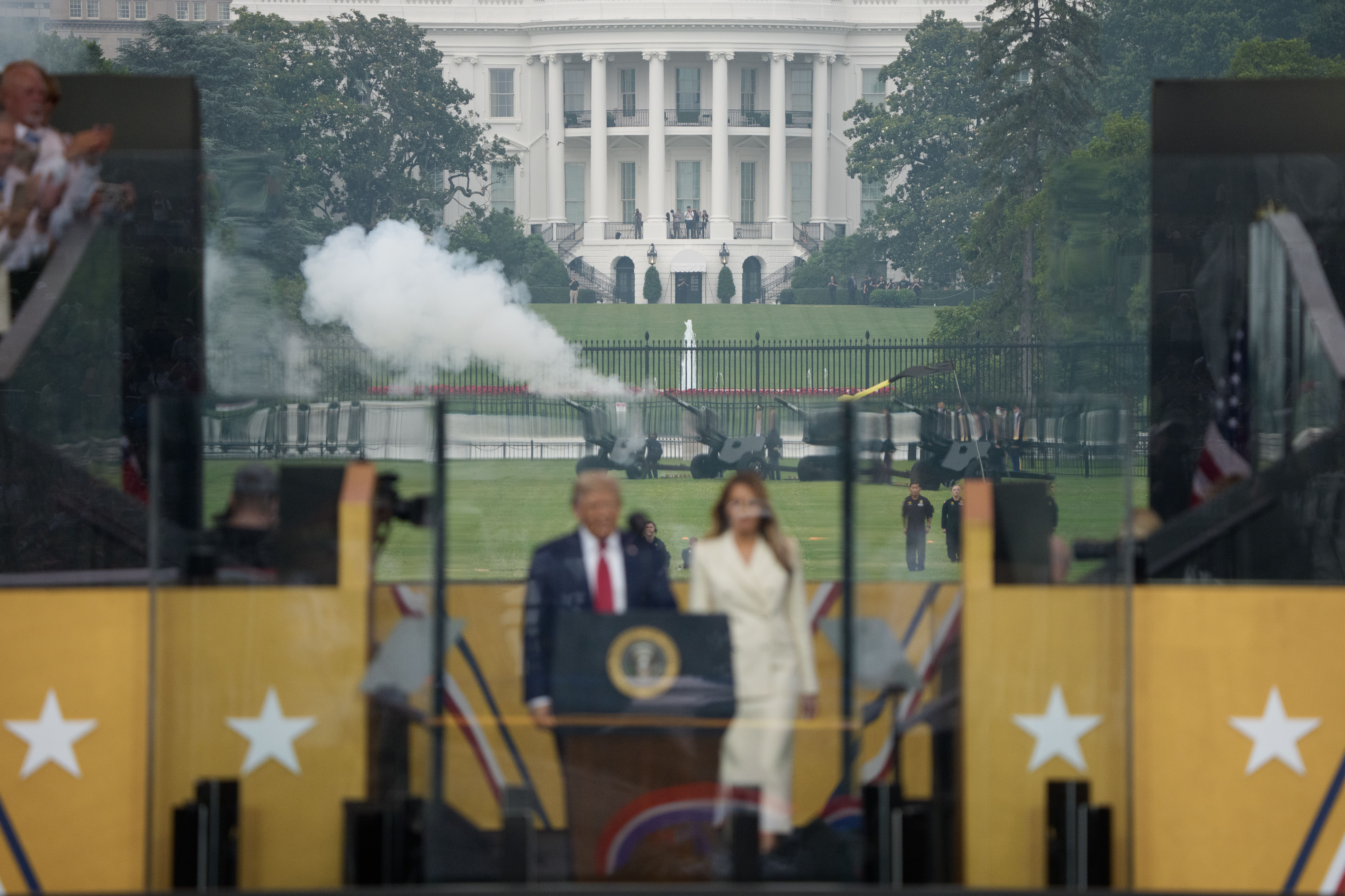 Artillery guns are fired as President Donald Trump and Melania Trump arrive at a reviewing stand for a military parade on June 14, 2025 in Washington, DC. 