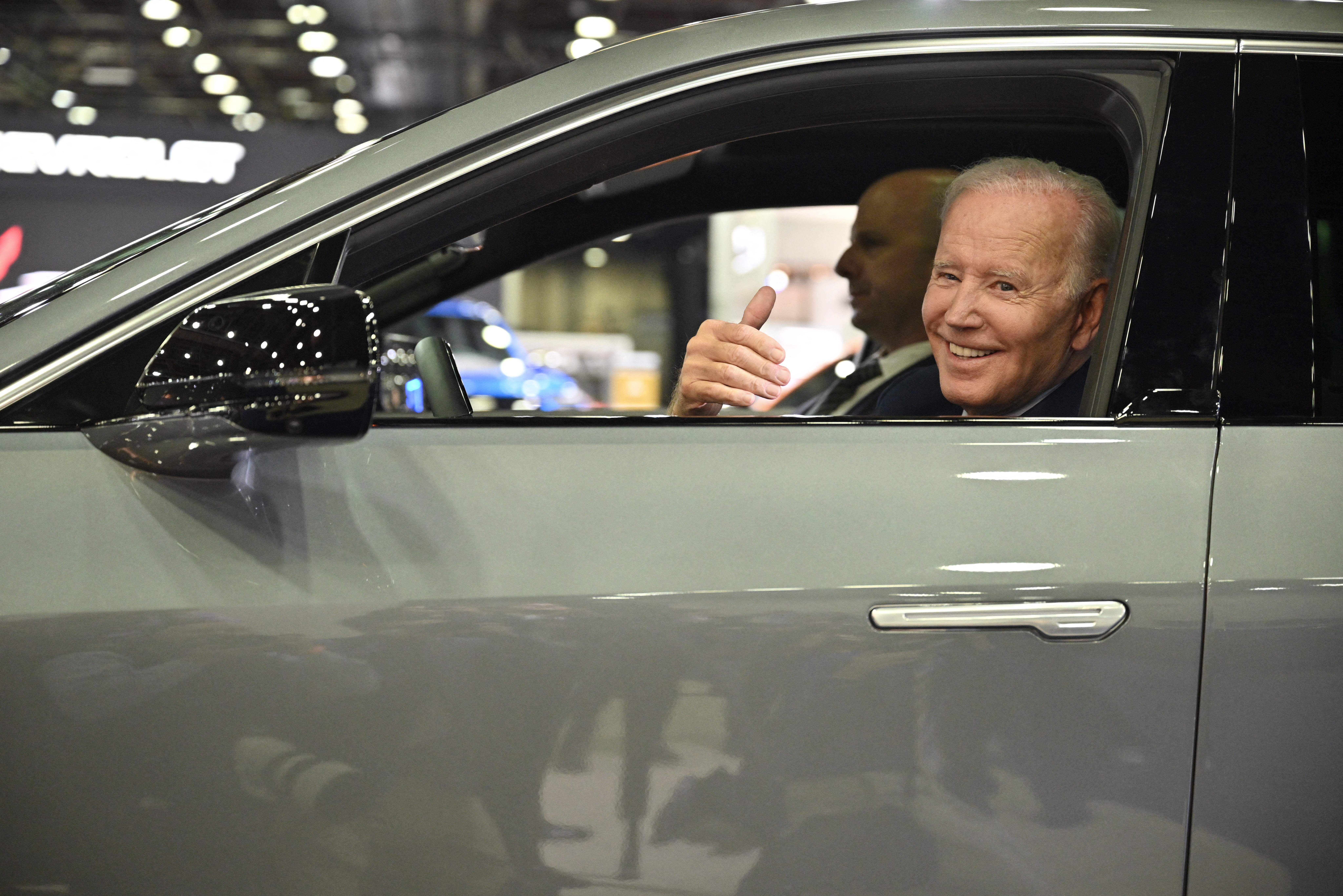 Biden sits at the wheel of a Cadillac Lyriq.