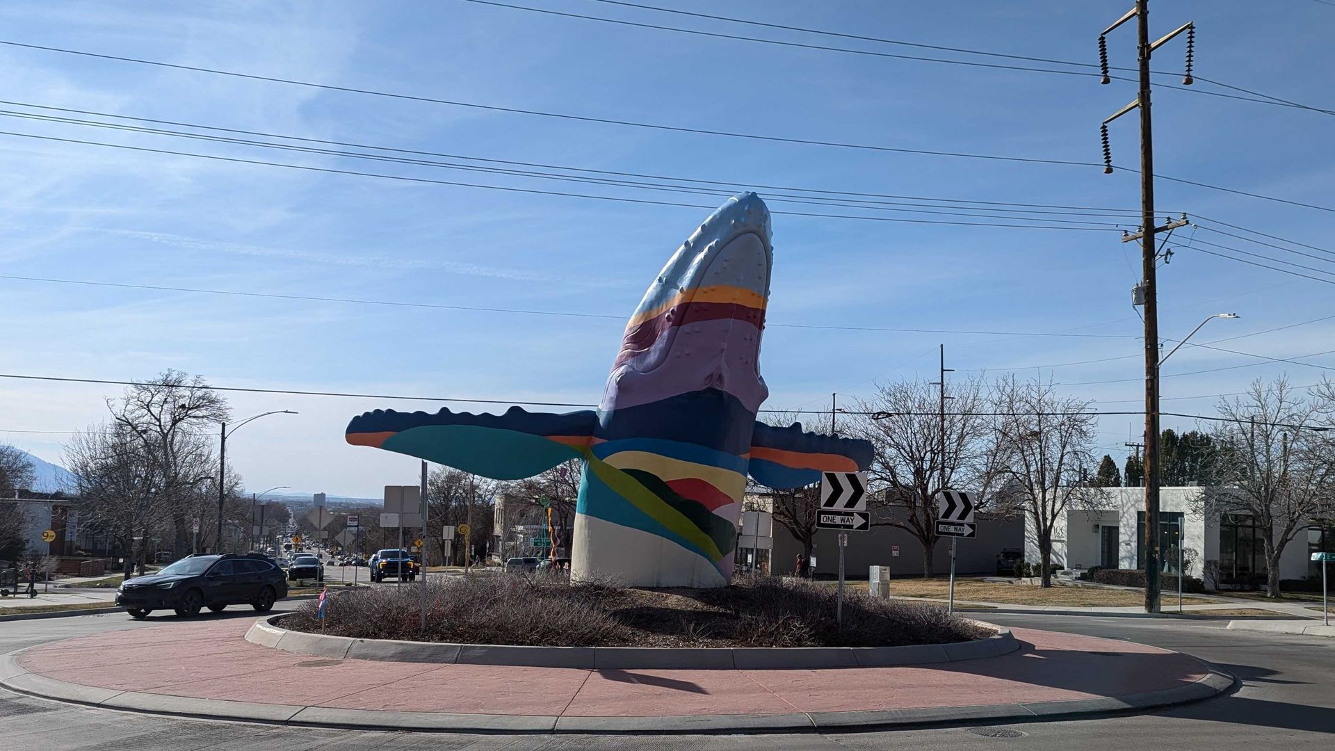 A whale juts out the ground in a roundabout in Salt Lake City