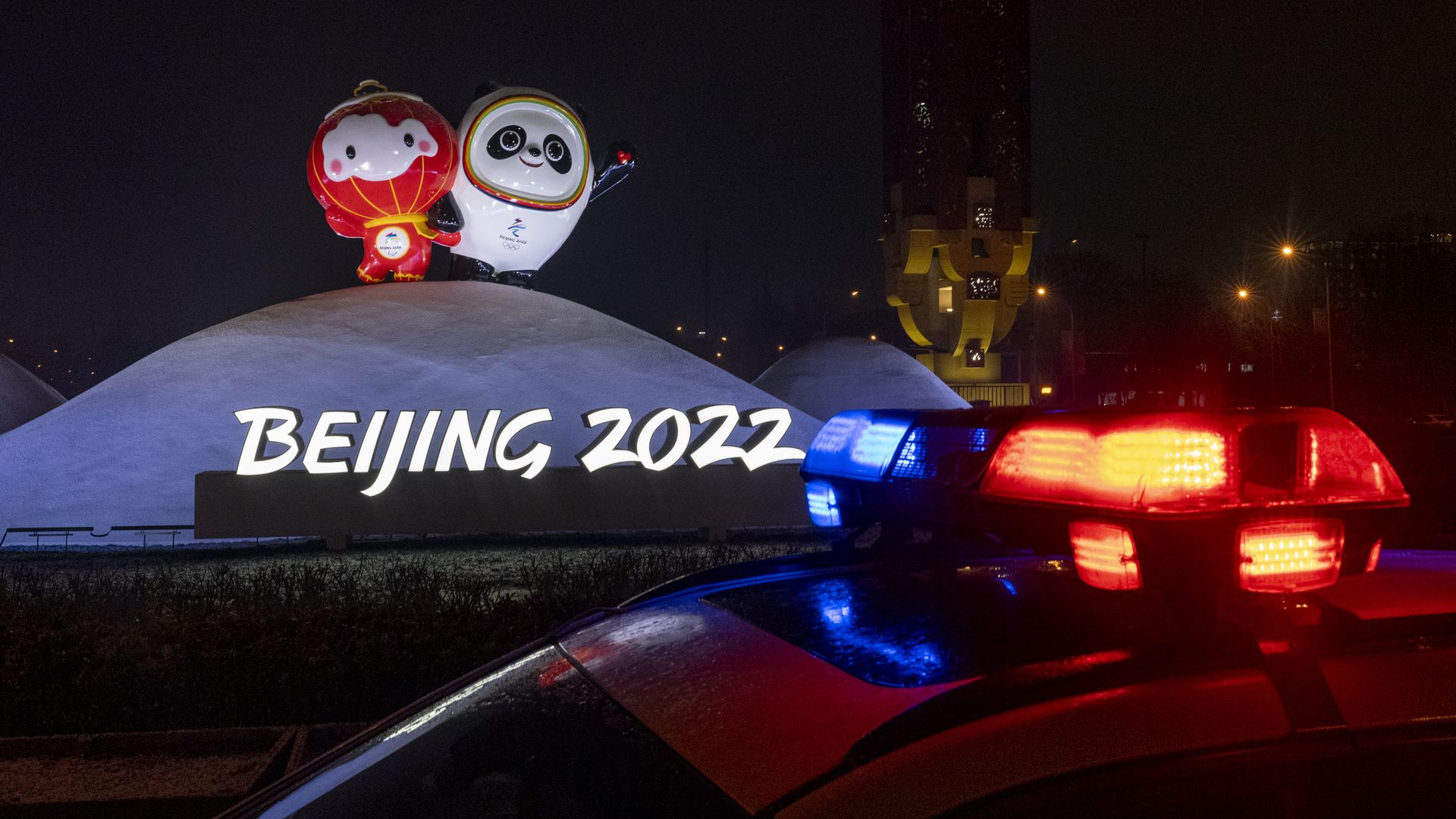 A police car is parked in front of a display with Beijing 2022 Winter Olympics official mascots on January 30, 2022 in Beijing, China