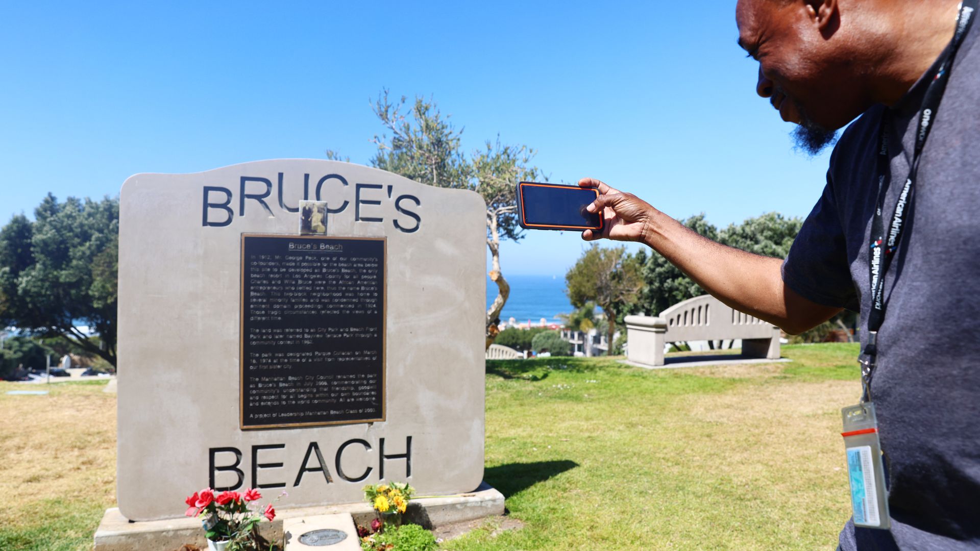 William Redmond III, of Atlanta, takes a photo of the historic plaque marking Bruce's Beach in Manhattan Beach, California. 