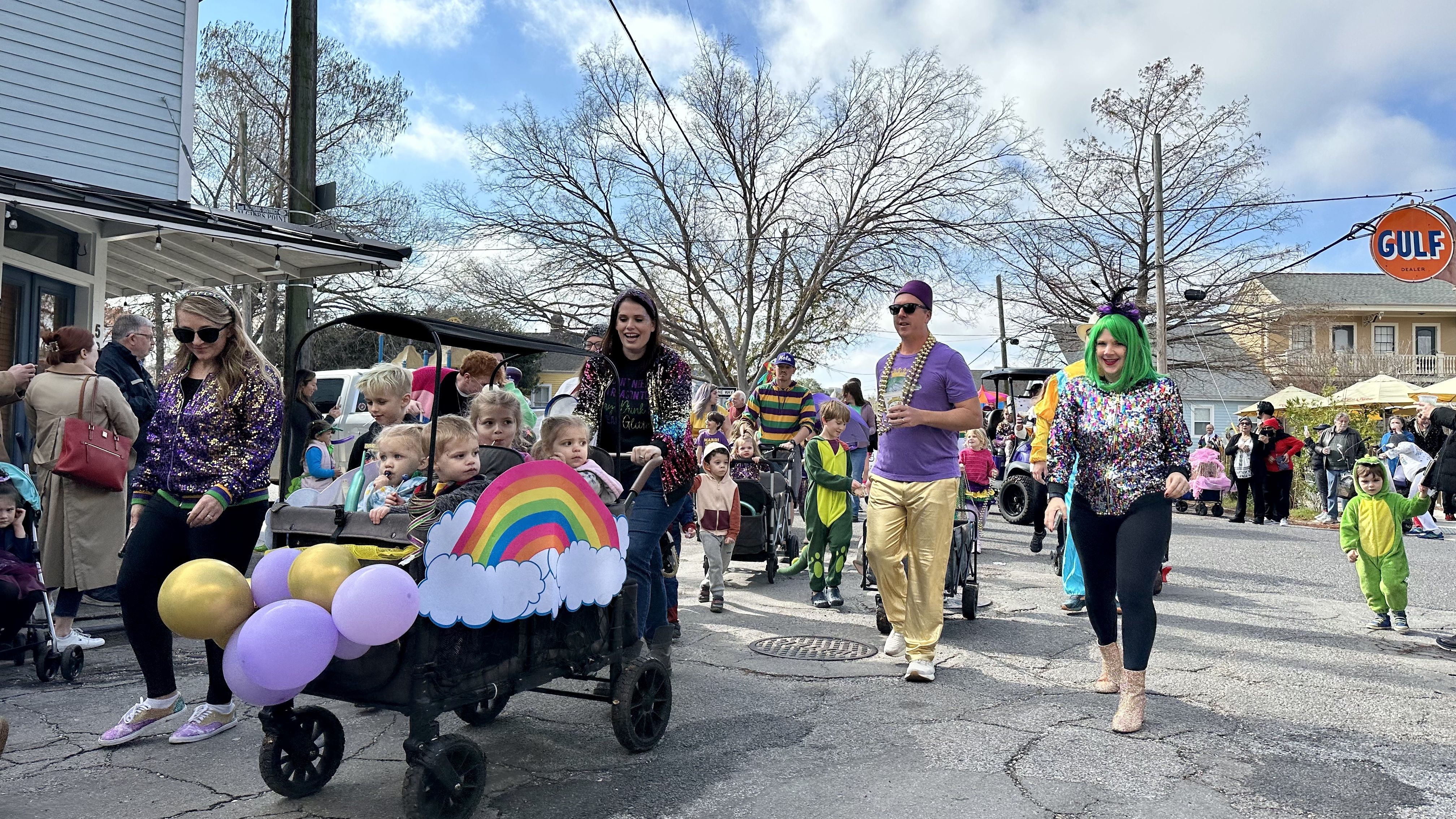Photo shows children in costume walking in the Krewe of Confetti Kids parade in Algiers Point in New Orleans.