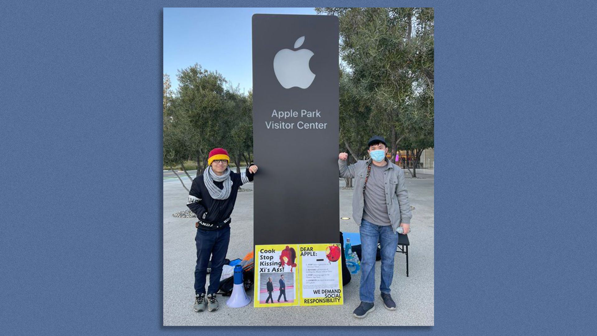 Two Chinese pro-democracy activists staging a hunger strike stand in front of Apple Park in Cupertino, California.