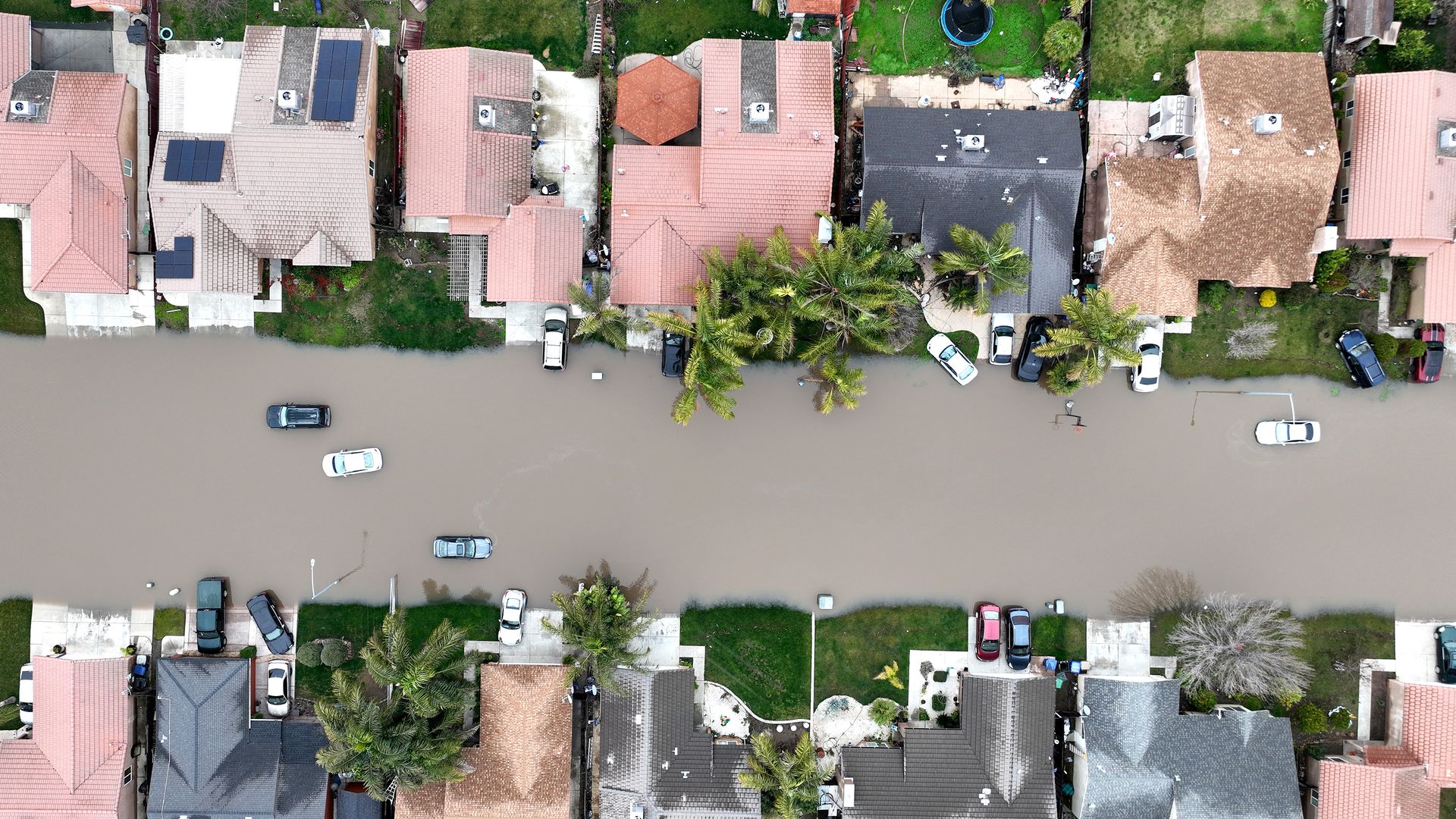 In an aerial view, homes are seen surrounded by floodwaters on January 11, 2023 in Planada, California.