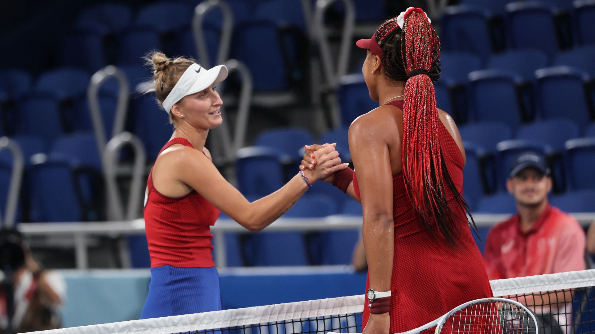 Czech Republic's Marketa Vondrousova with Japan's Naomi Osaka after winning their Tokyo 2020 Olympic Games women's singles third round tennis match at the Ariake Tennis Park in Tokyo on July 27