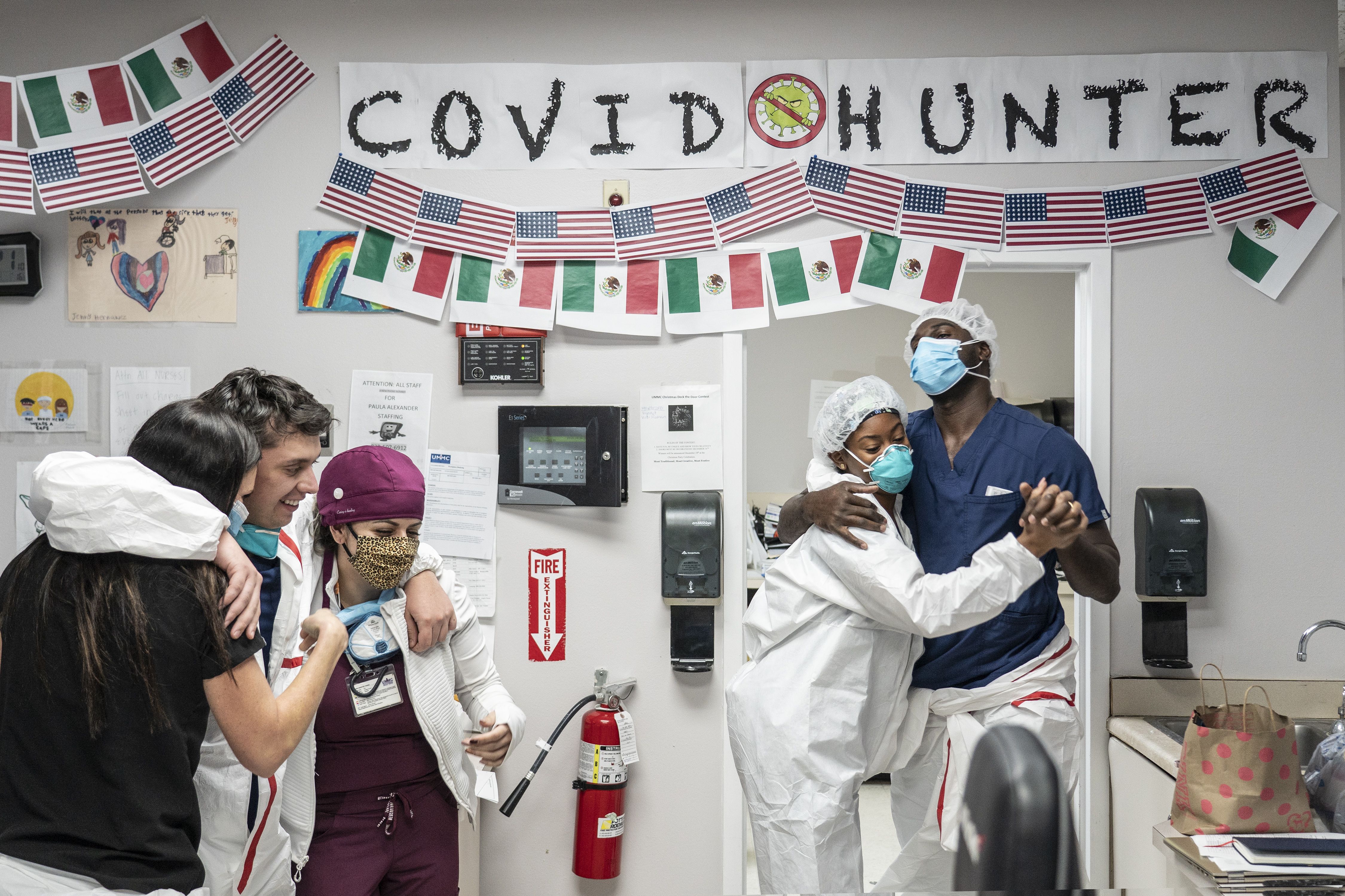 Health care workers dance to a Christmas song at nursing station in the COVID-19 intensive care unit (ICU) at the United Memorial Medical Center on December 10
