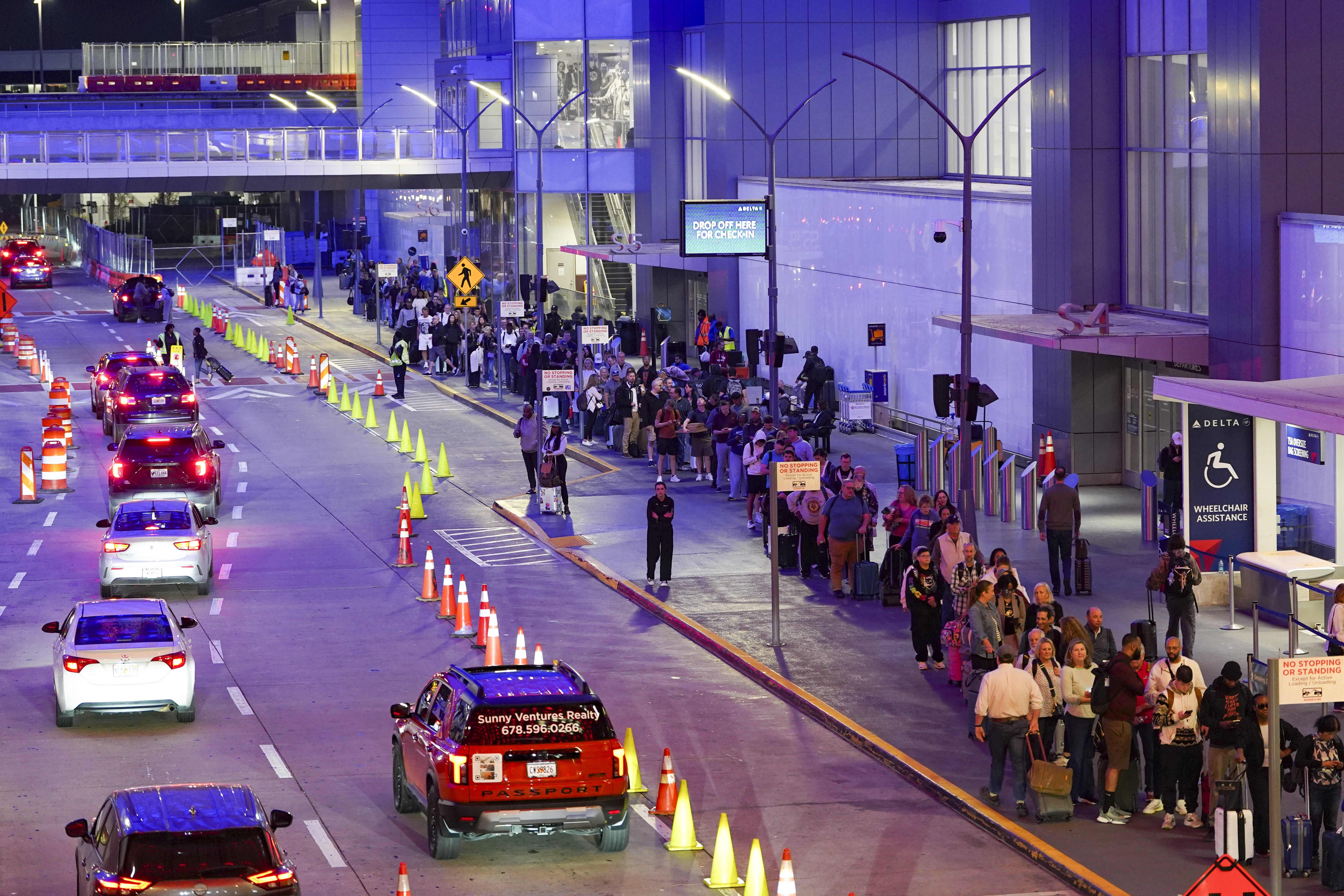 Travelers wait in long lines early in the morning at Atlanta Hartsfield-Jackson International Airport on March 27, 2026 in Atlanta, Georgia. The travel disruptions continue as hundreds of TSA agents quit or work without pay during a partial government shutdown. U.S. President Donald Trump deployed I