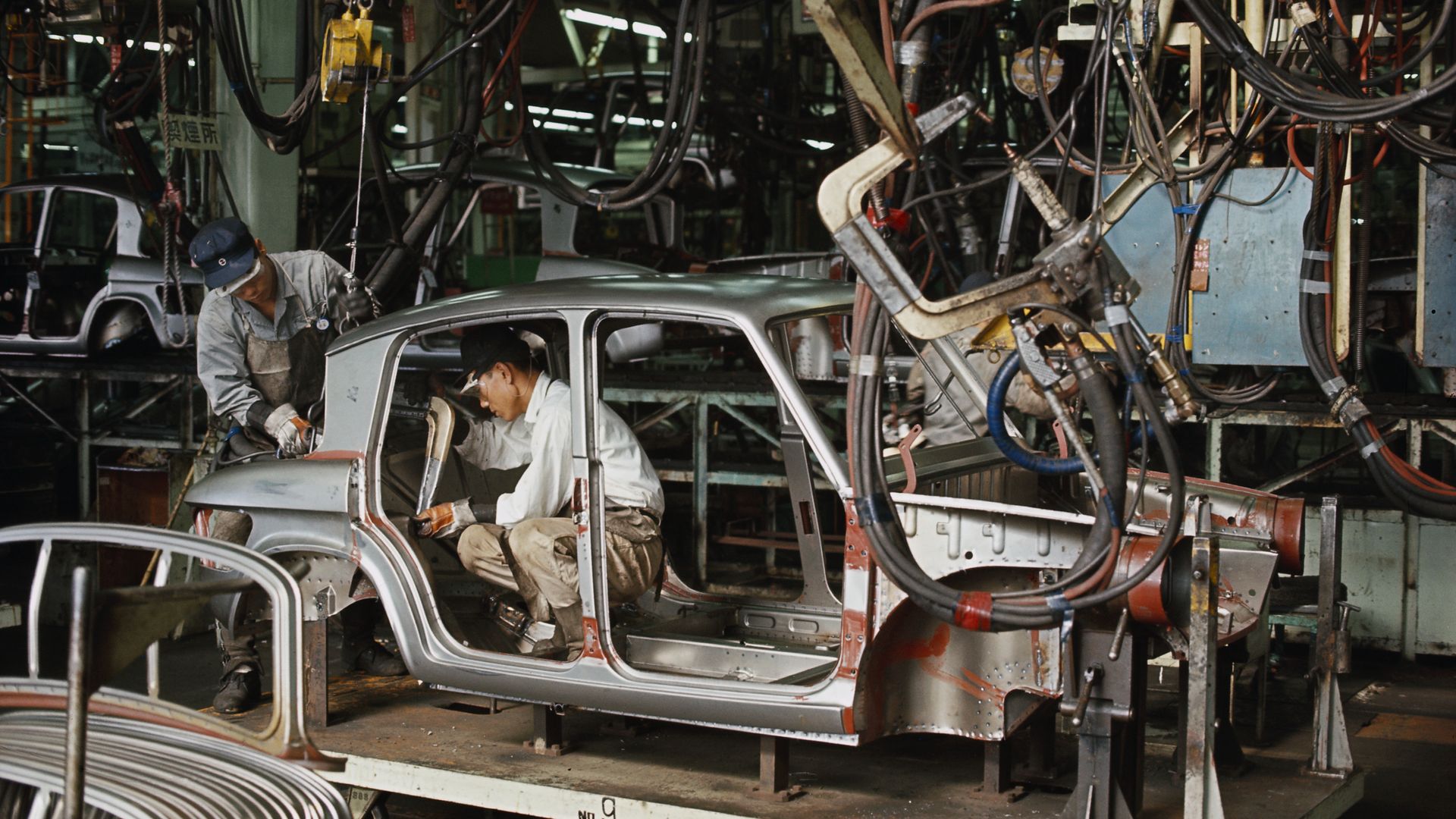 Factory Workers Assembling Car on Line