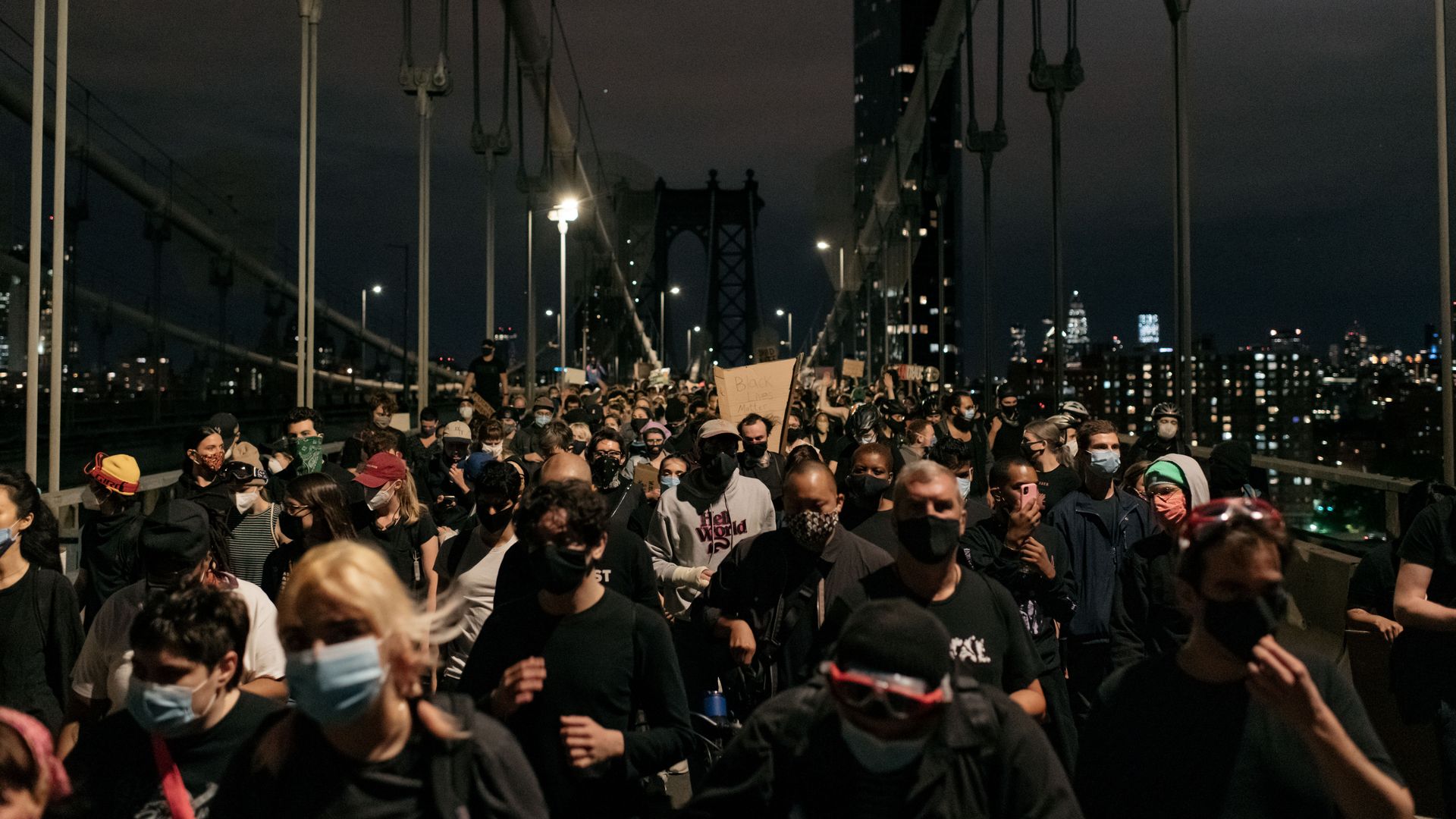 Protesters denouncing police brutality and systemic racism exit the Manhattan Bridge 