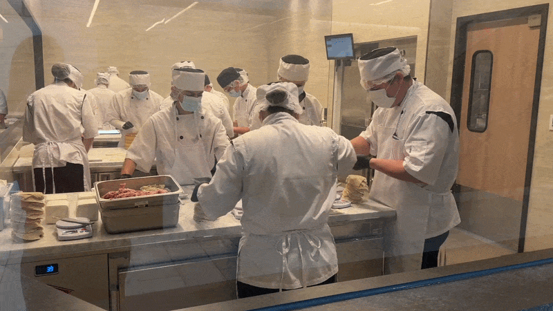 A gif of people preparing dumplings.
