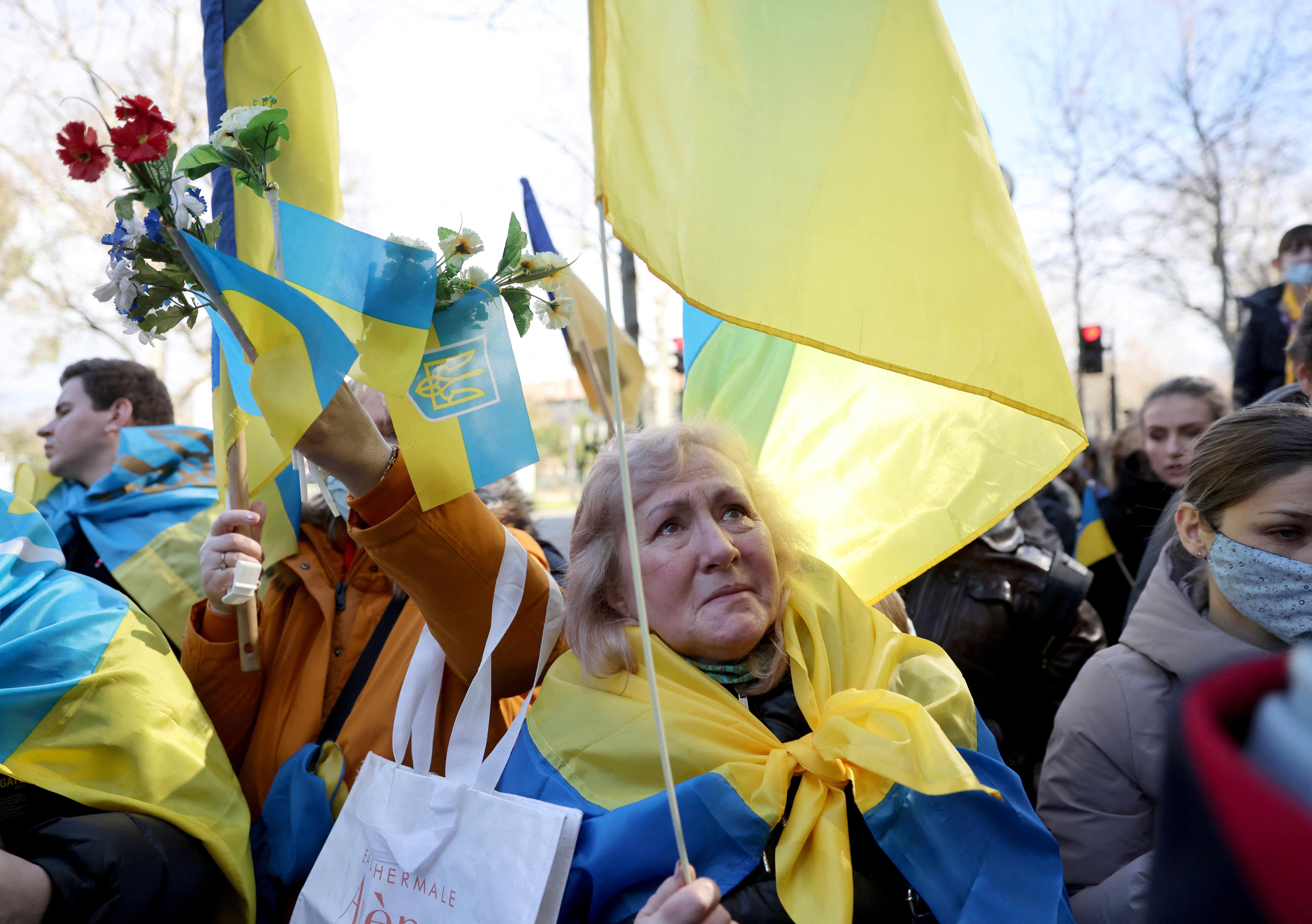 Protesters waving and wearing Ukraine's flag in Paris on Feb. 24.
