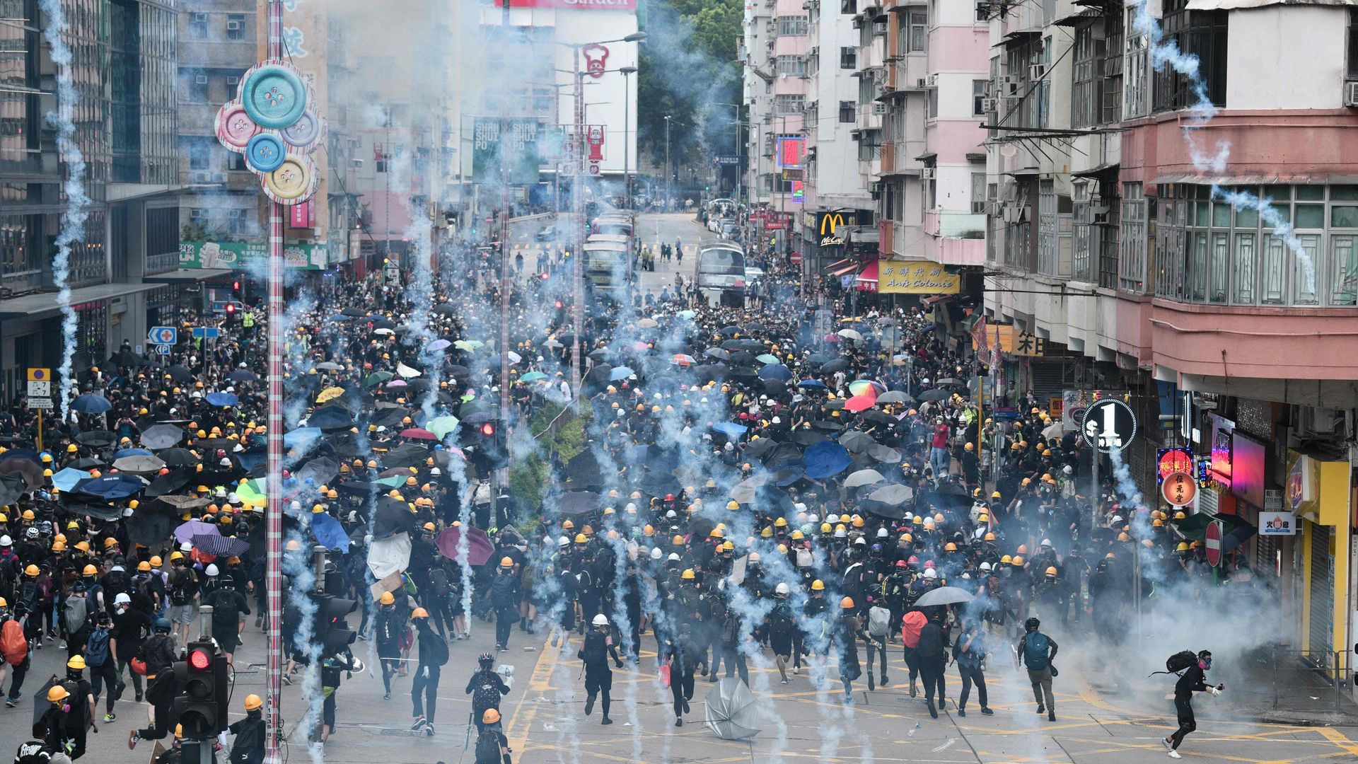  protesters throw back tear gas fired by the police during a demonstratrion against the controversial extradition bill in Sham Shui Po district in Hong Kong