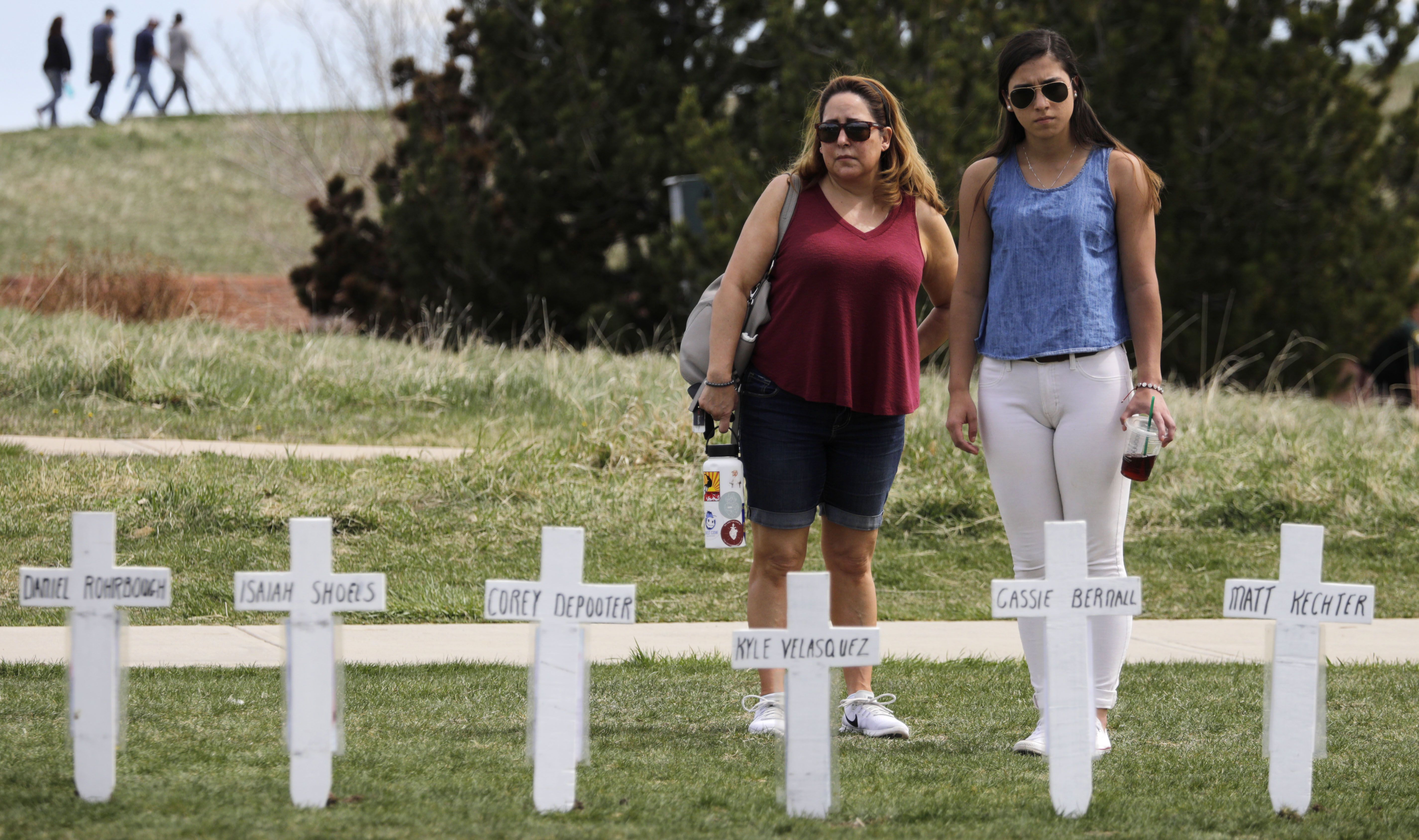  Michelle Aguayo of Morrison, Colorado and her daughter, Ciara Shannon, of Boulder, Colorado, stop by an ad hoc display of crosses with the names of students killed in the 1999 attack.