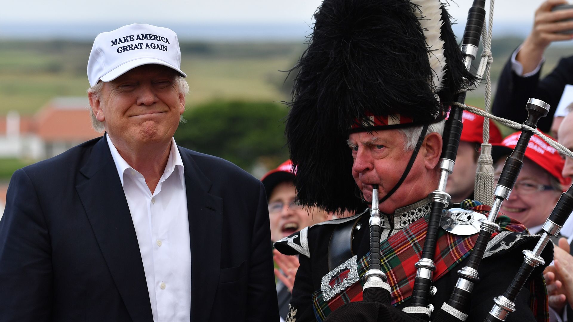 A bagpipe player next to Donald Trump as he arrives to his Trump Turnberry Resort.