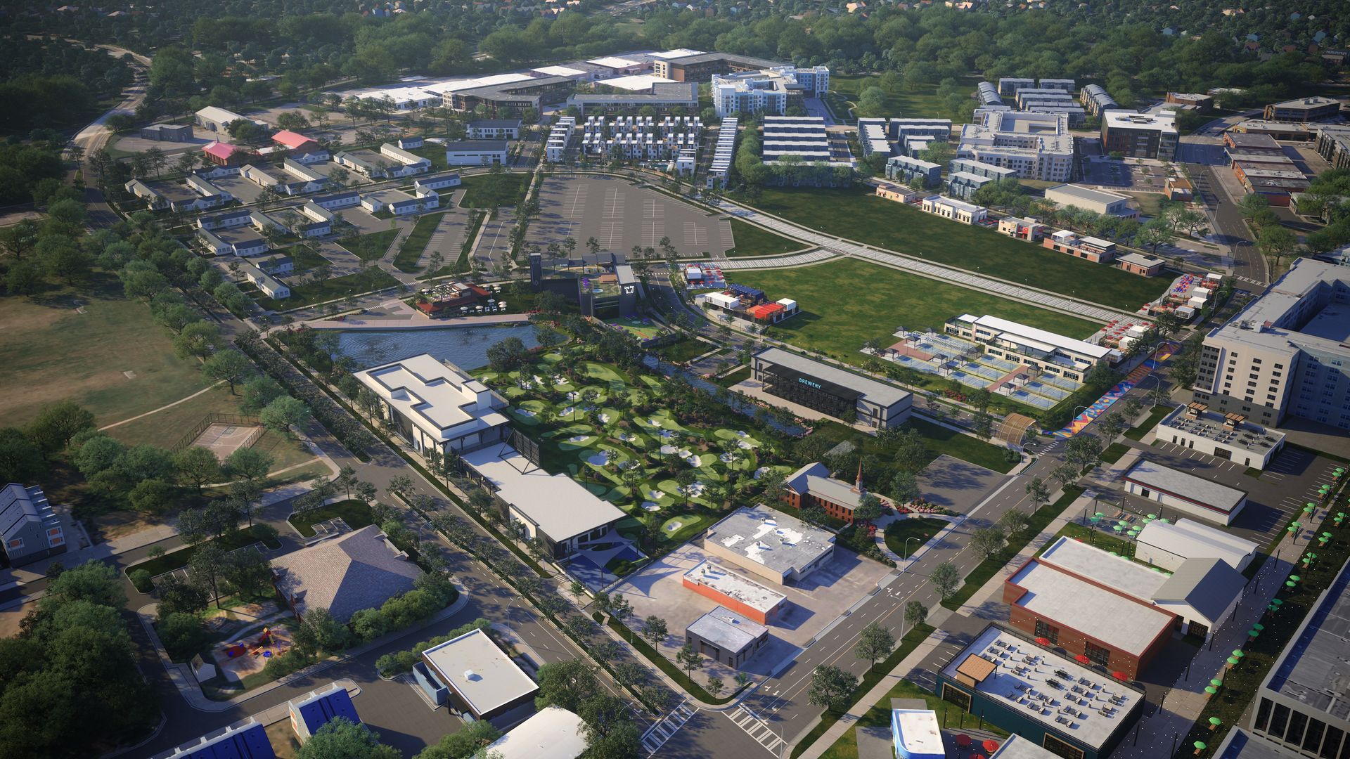 Aerial view of a vibrant urban area with green parks, a golf driving range, multiple buildings, parking lots, sports courts, and tree-lined streets under daylight.