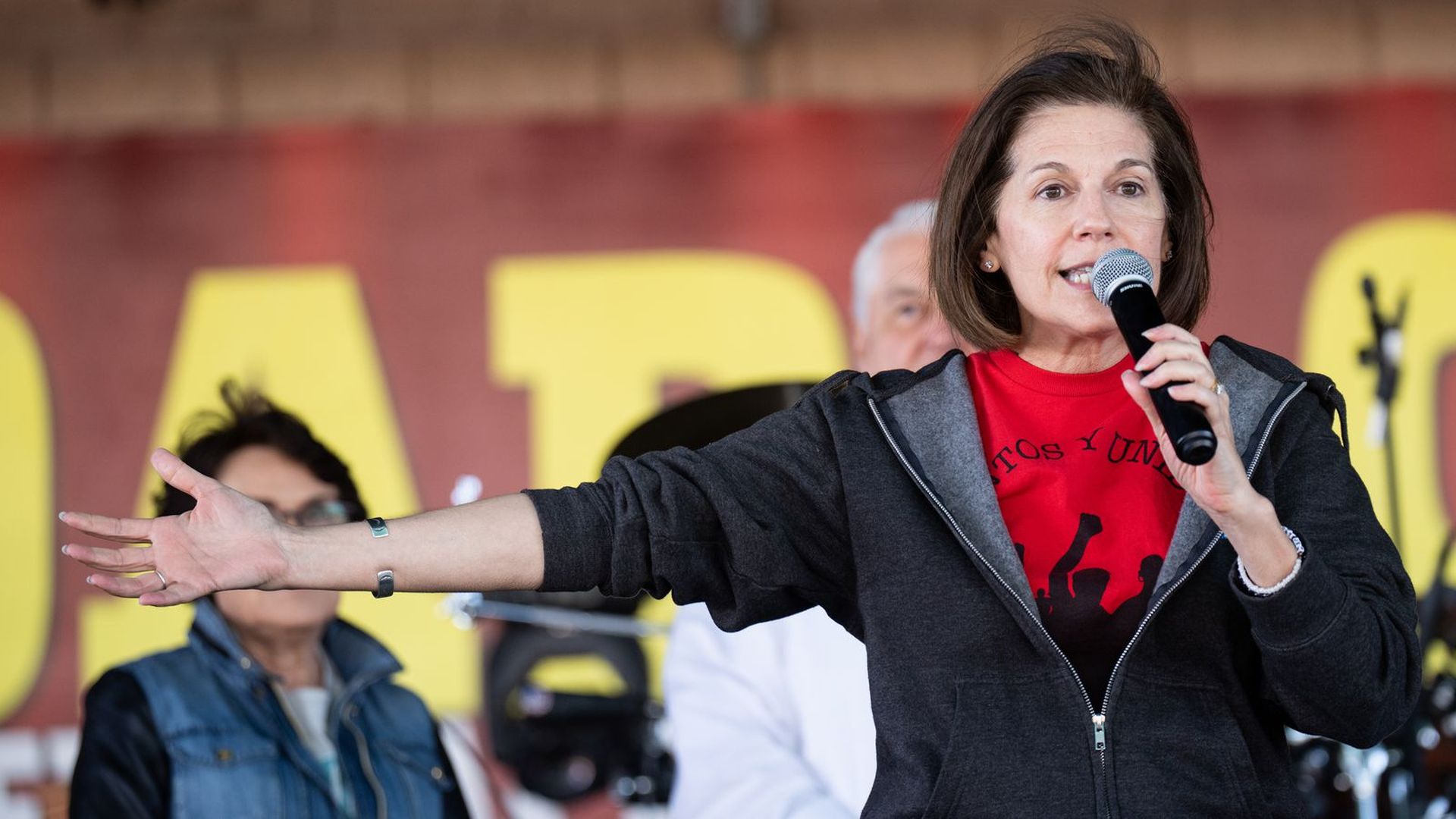 U.S. Sen. Catherine Cortez Masto stands with a microphone to her face