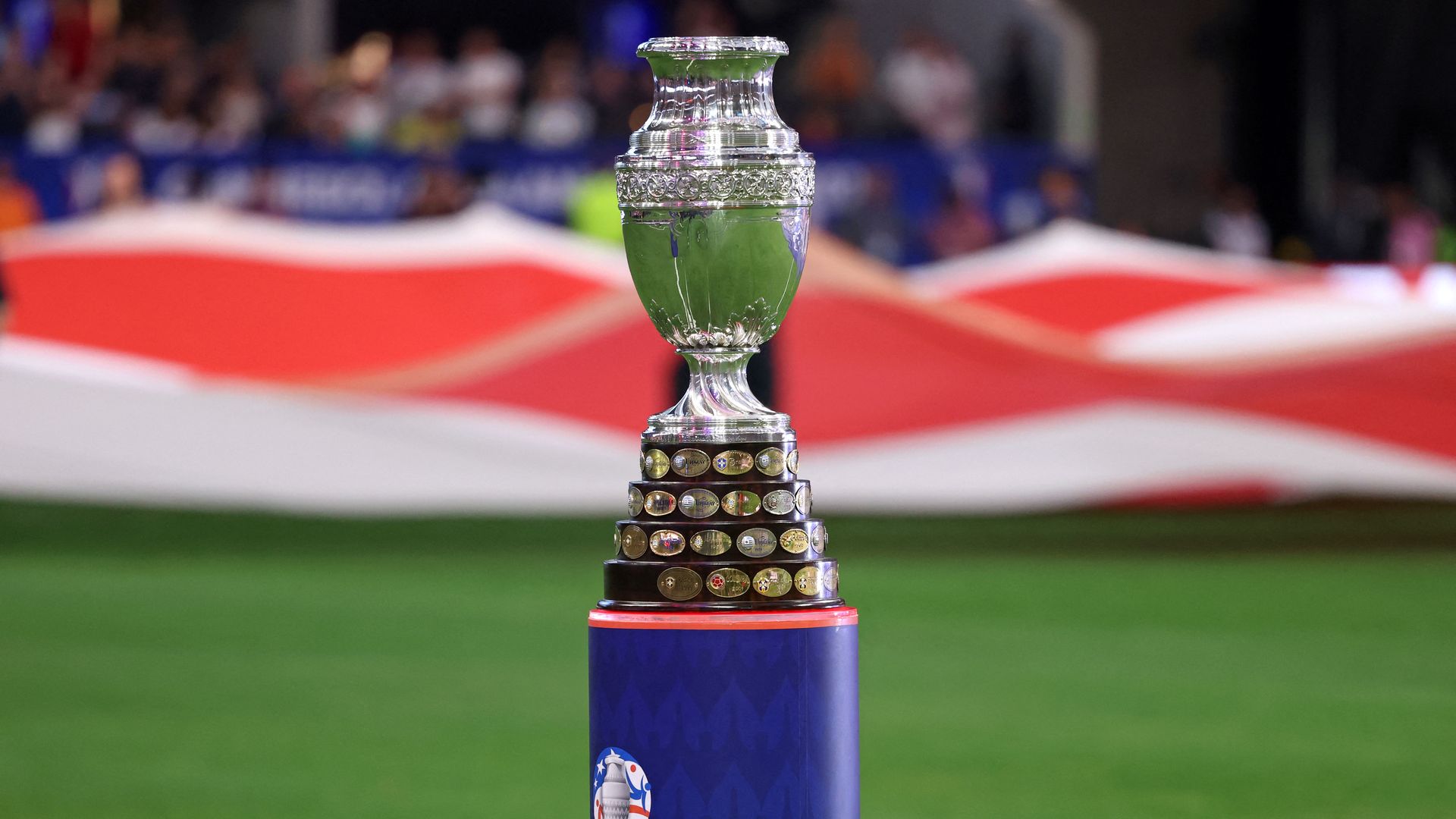 A trophy in the middle of a soccer pitch.