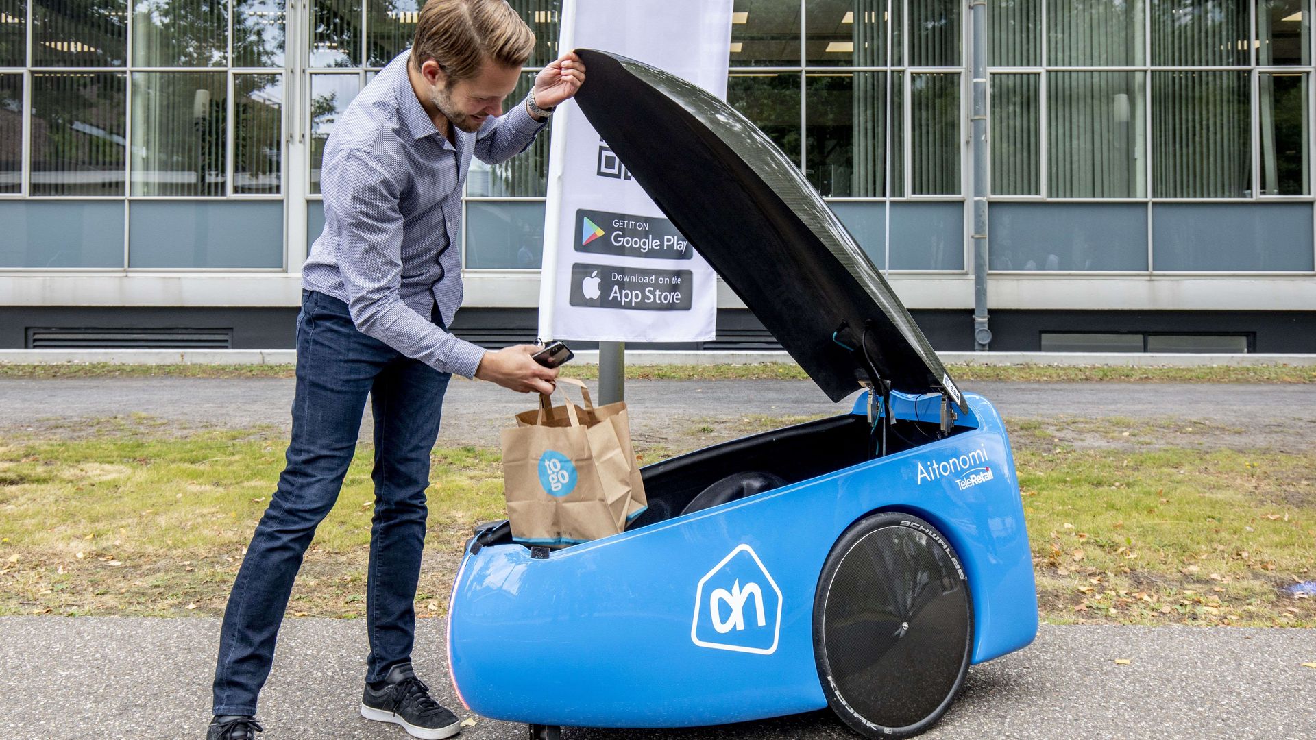 A man using a delivery robot.