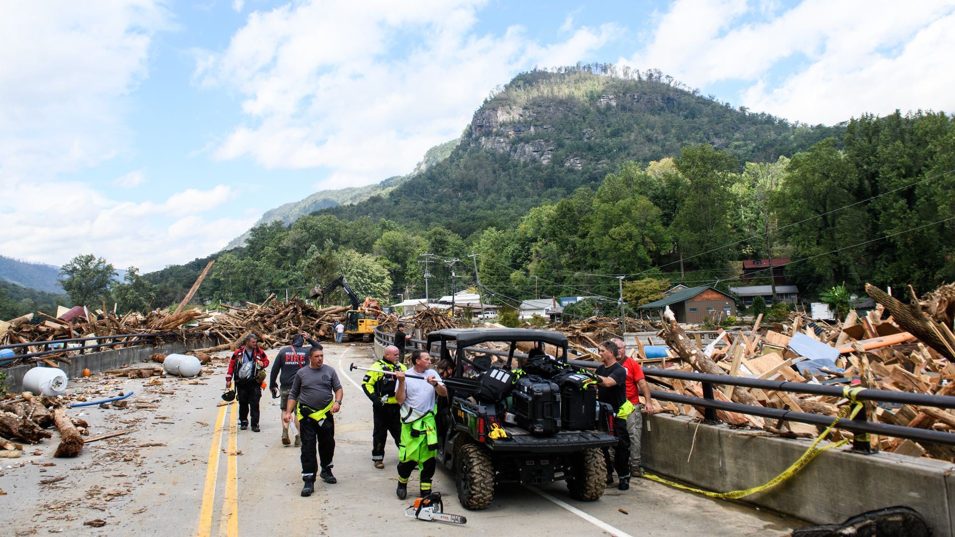 Photo shows first responders cleaning a bridge after Hurricane Helene.
