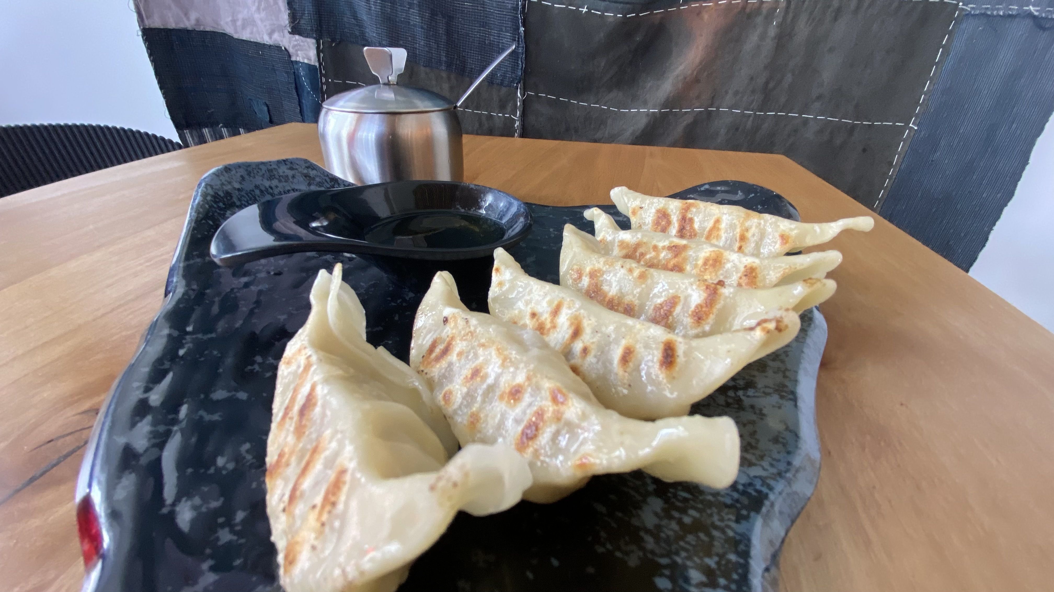 A plate of fried dumplings. 
