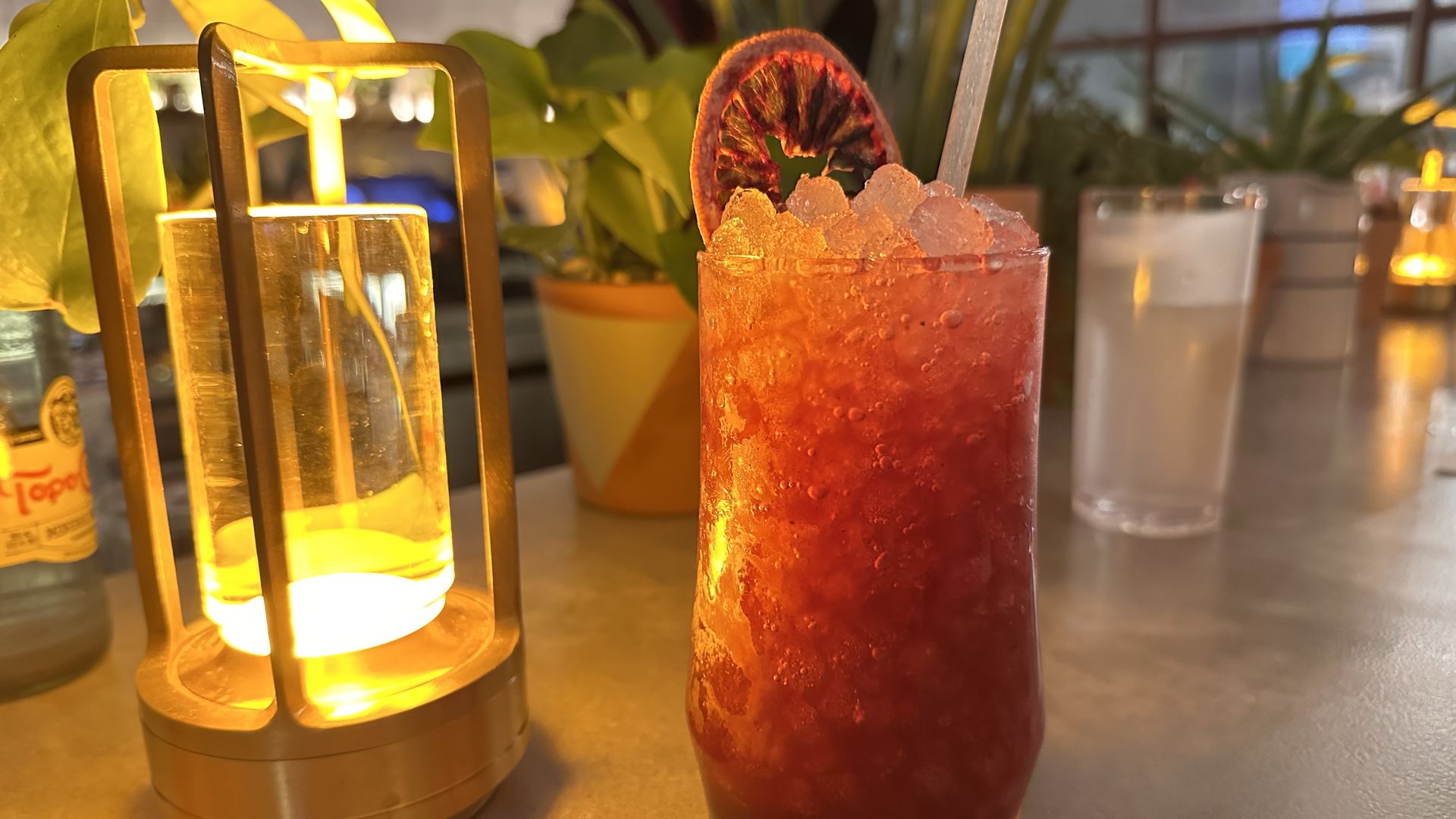 A photo of a reddish cocktail on a bar 