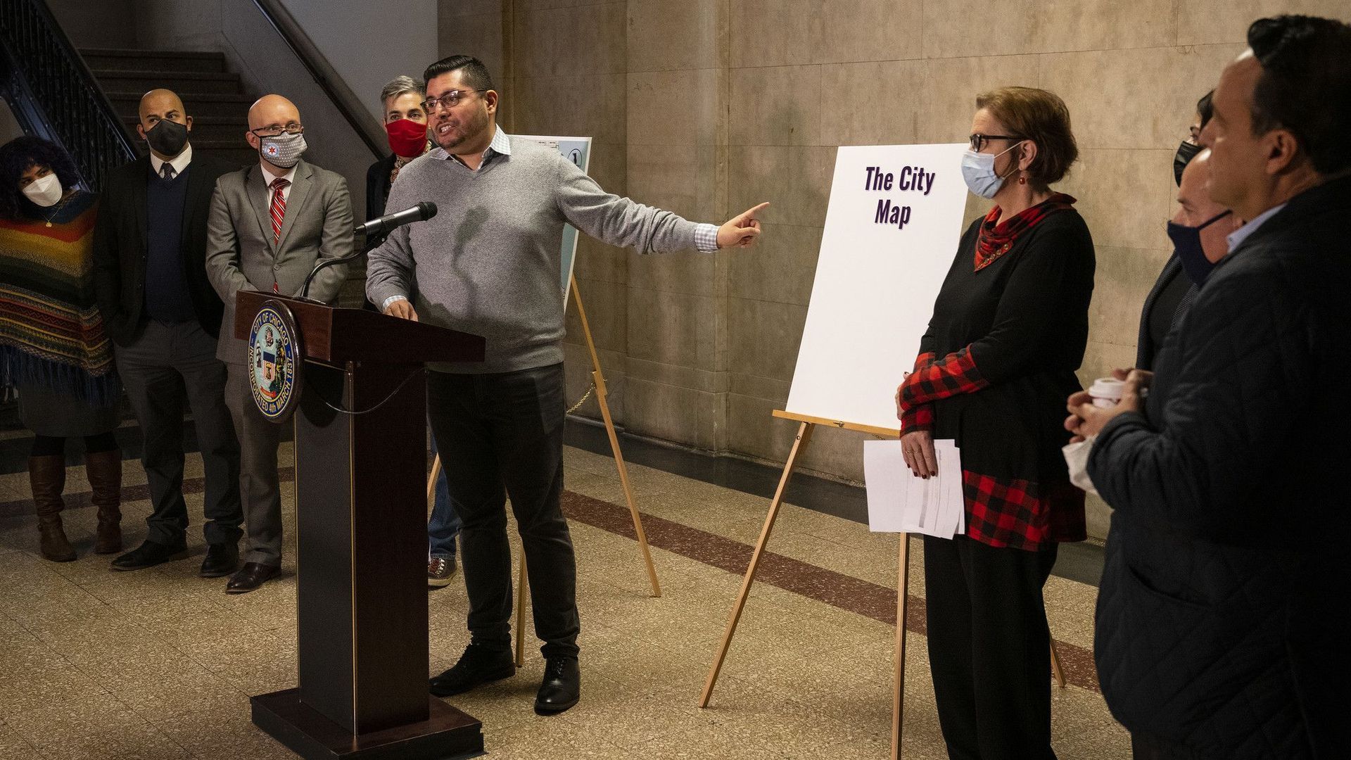 Politician in front of board