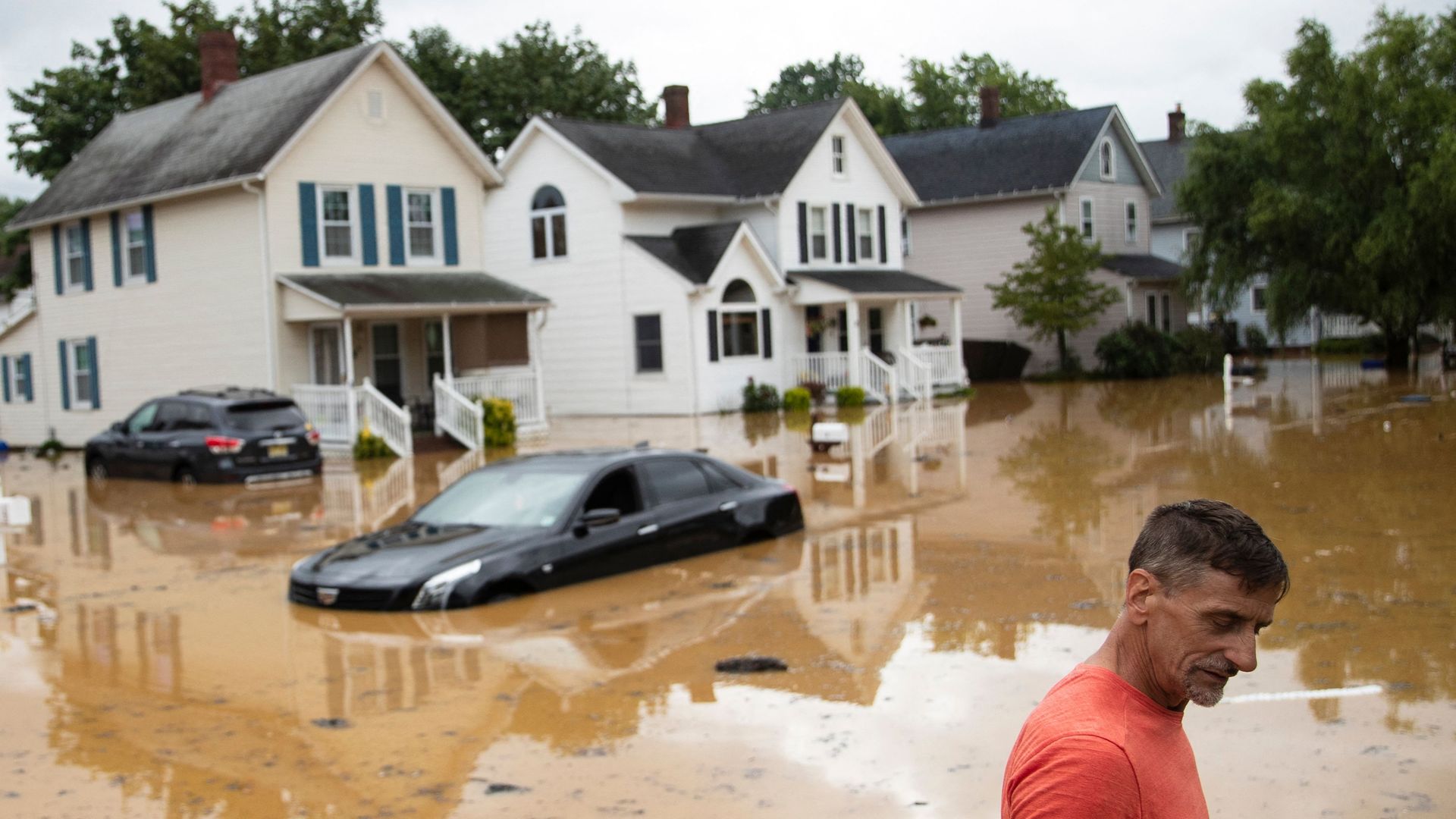 Bruce, an evacuated resident, wades through high water following a flash flood, as Tropical Storm Henri makes landfall, in Helmetta, New Jersey, on August 22