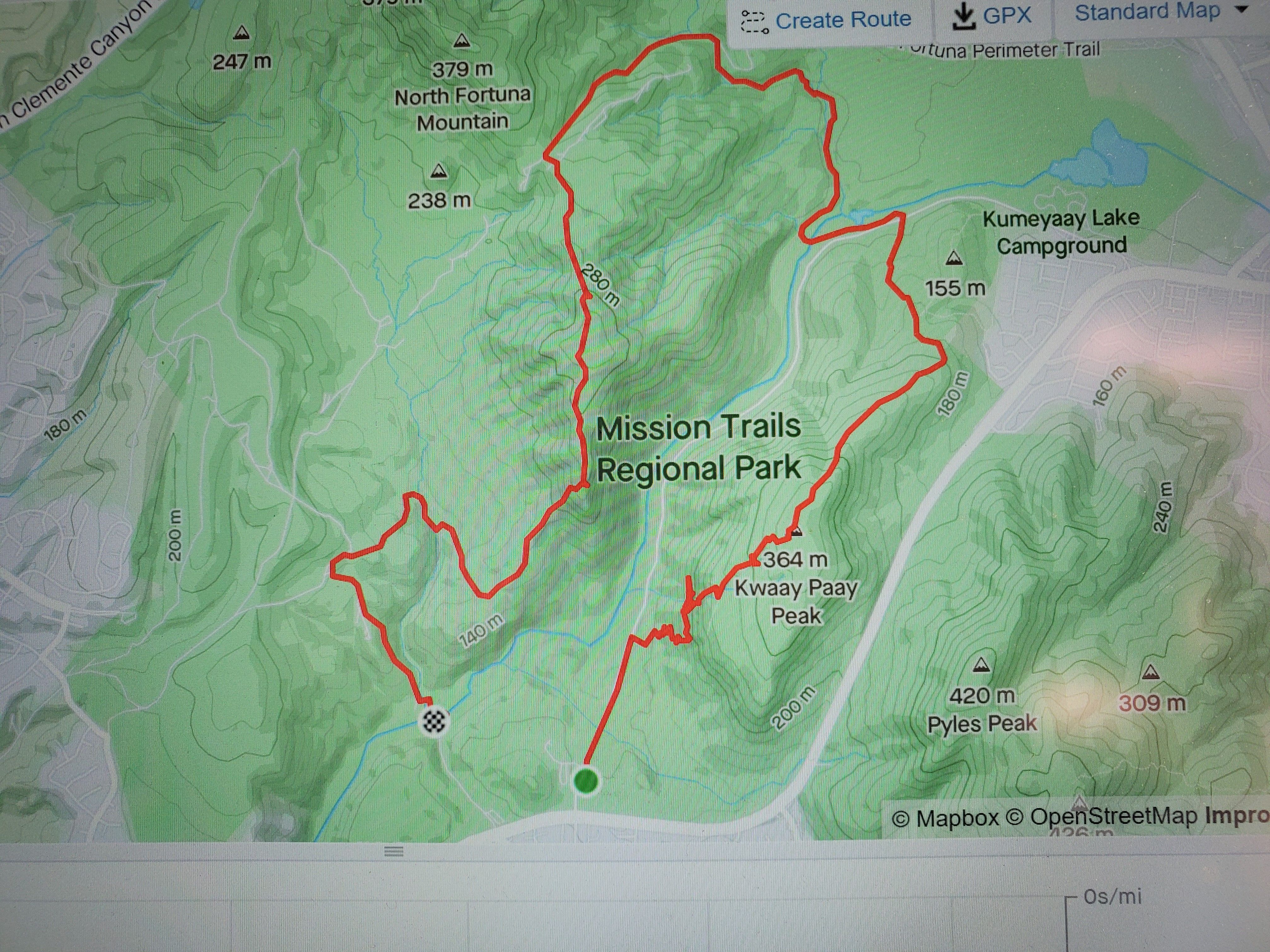 Topographic map of Mission Trails Regional Park outlined in red, with green hills, contour lines, and blue streams; North Fortuna Mountain (379 m) to the north, Kumeyaay Lake Campground to the east.