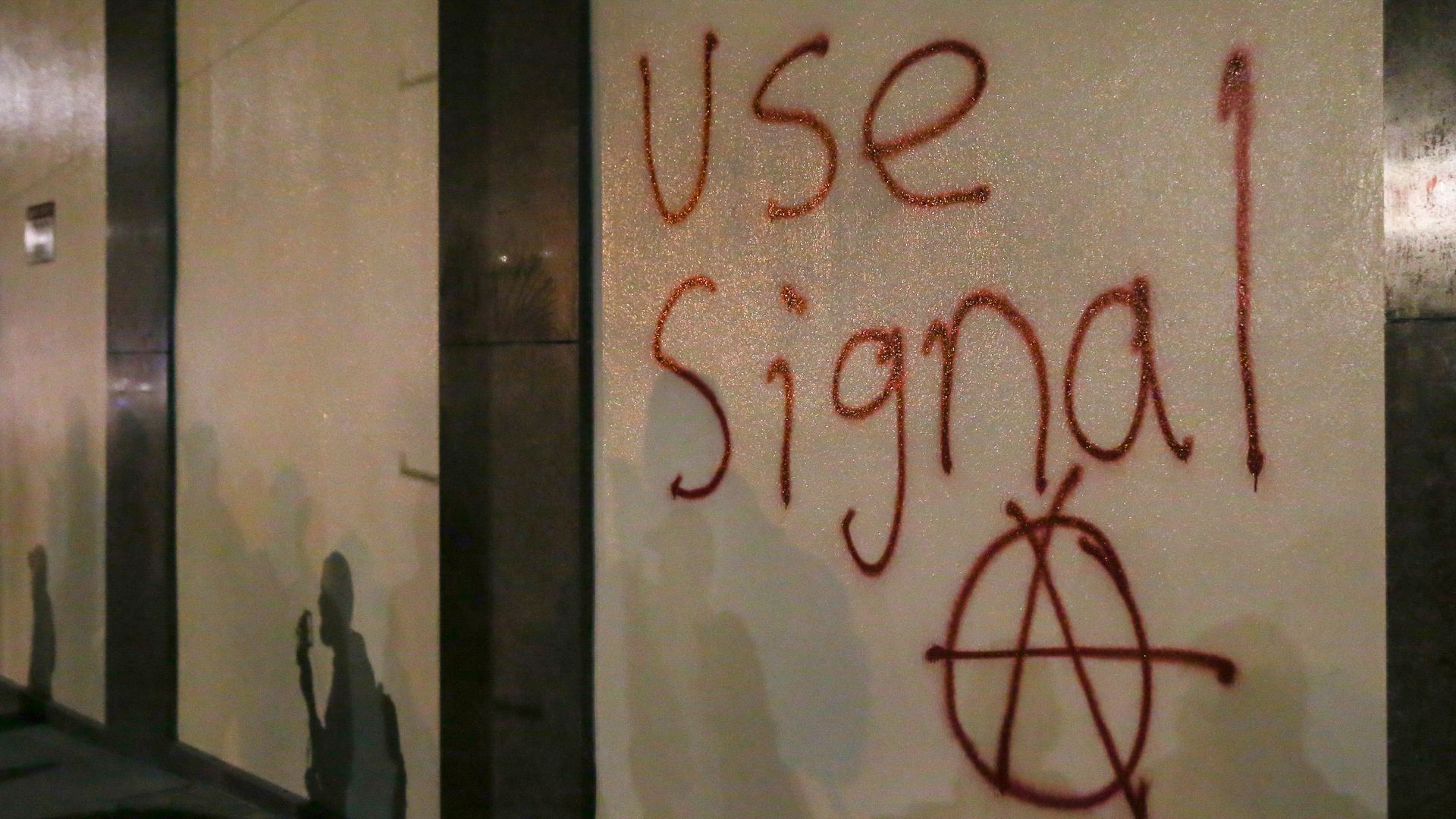 Graffiti reading "Use Signal" above an anarchy symbol. 