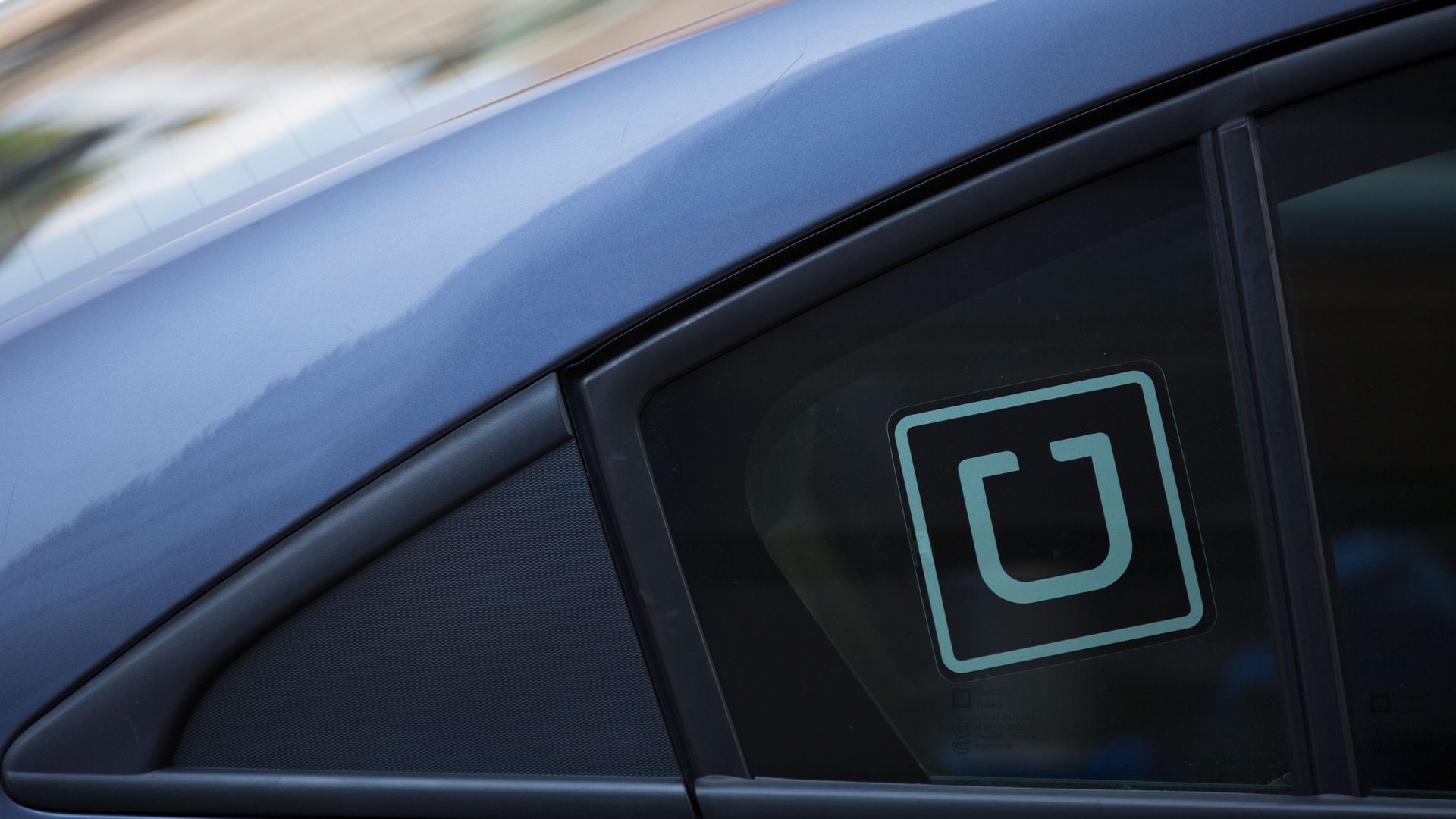 A car with an Uber sticker in the window