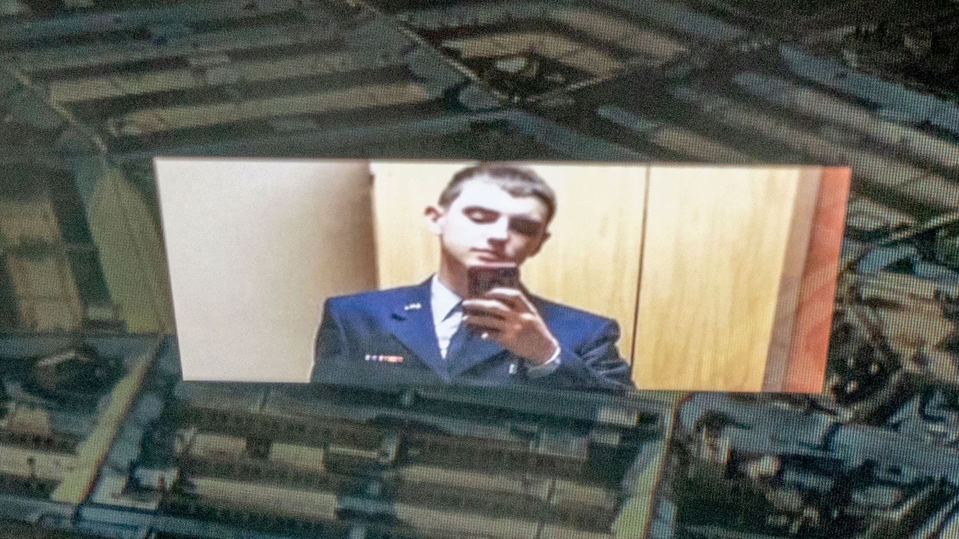 An image of the Discord logo and suspect Jack Teixeira reflected in an image of the Pentagon.