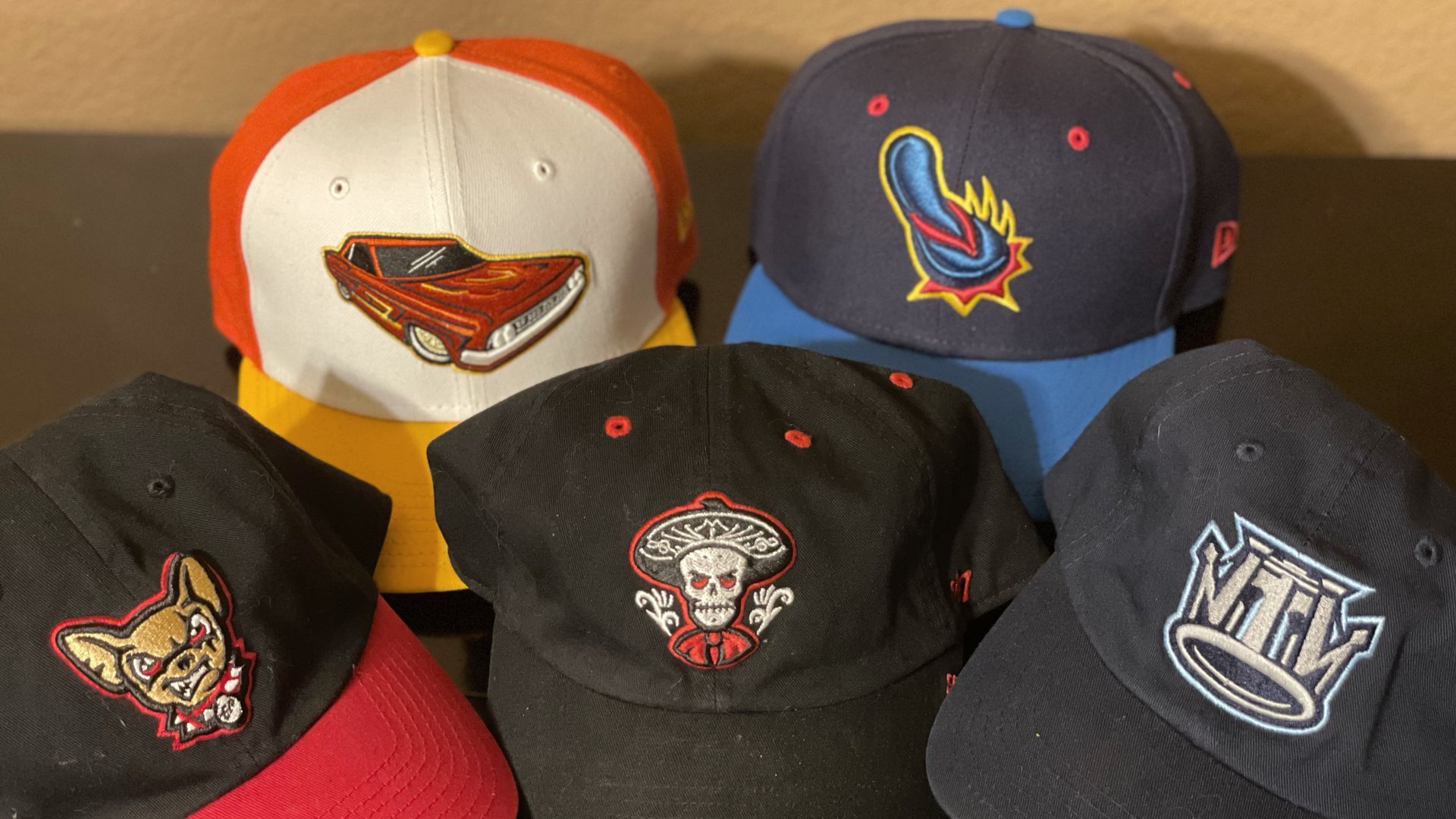 Team hats for the Lowriders de Fresno, the Flying Chanclas de San Antonio and the Mariachis de Nuevo México,  some of the teams in Minor League Baseball's Copa de la Diversión.