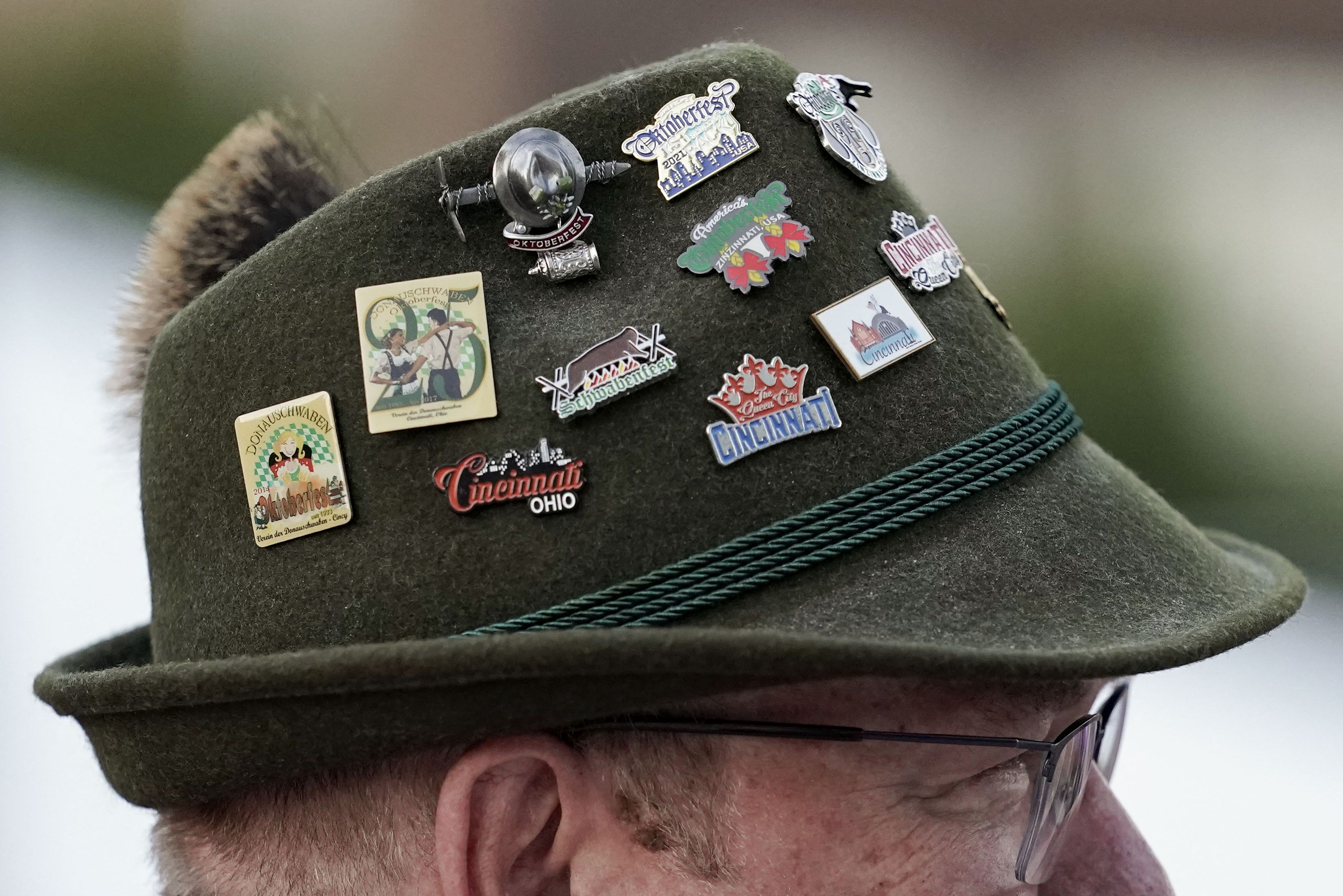 A man wears souvenir pins on his alpine hat during Oktoberfest Zinzinnati in 2021.