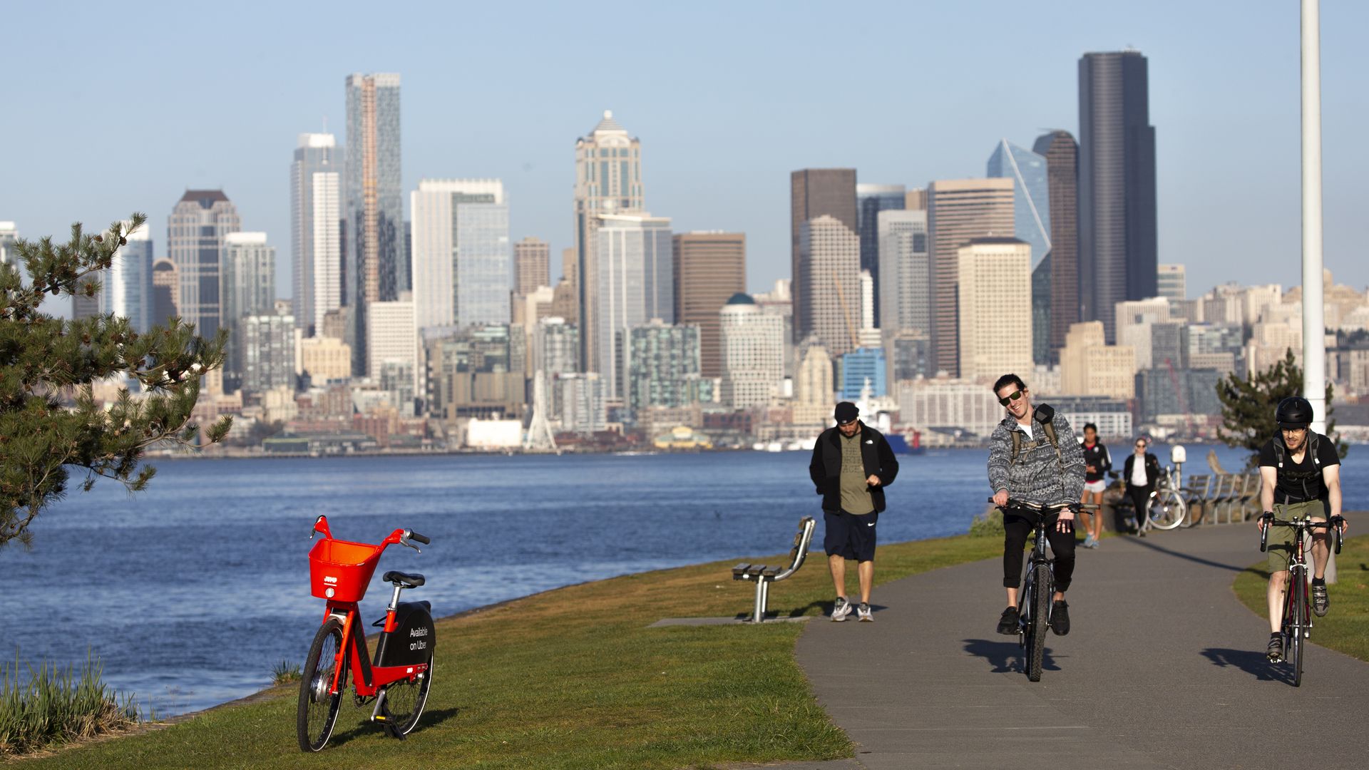 A photo of people walking and enjoying the sun near Alki in Seattle. 